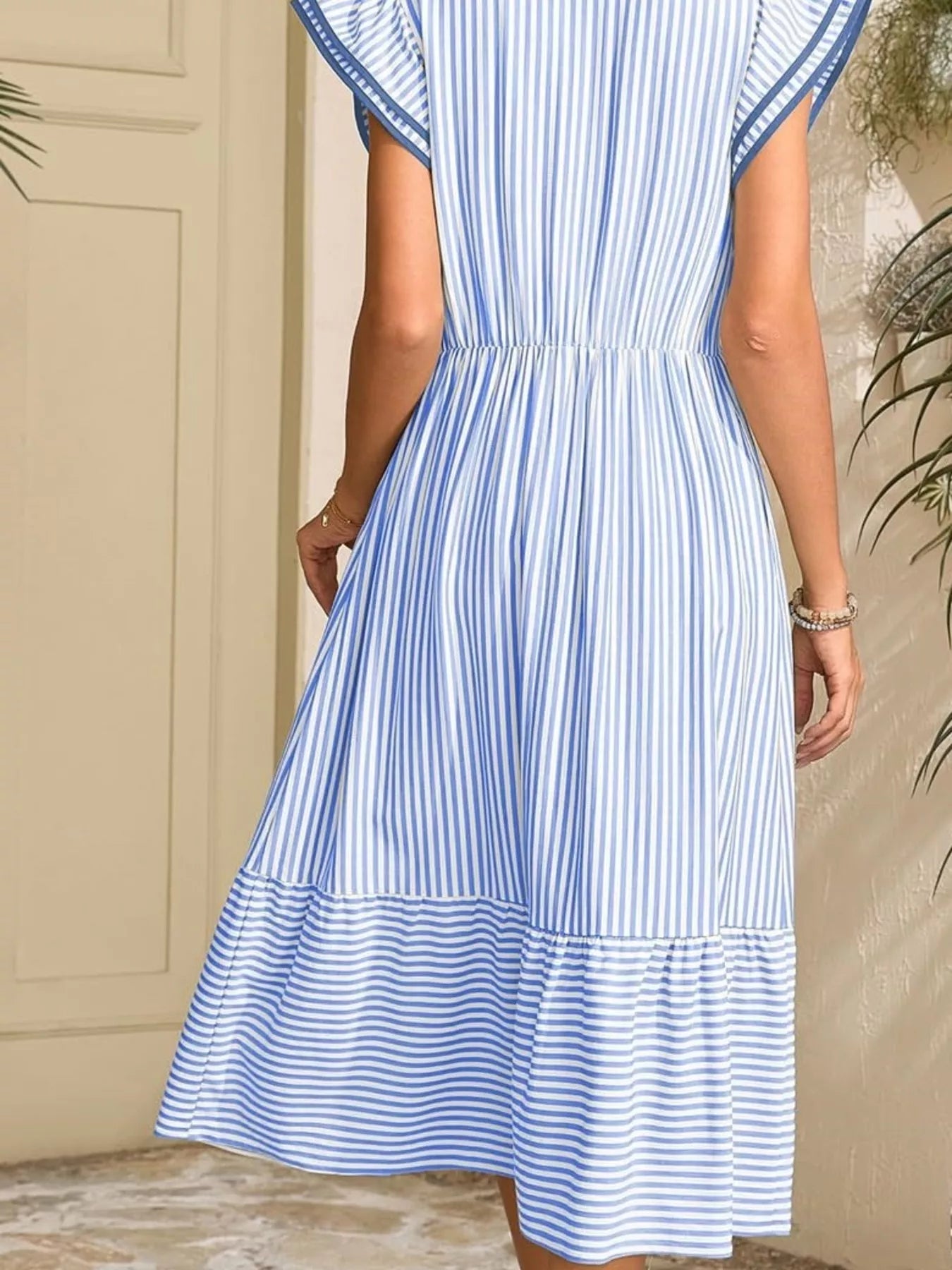 Blue-and-white striped dress with pockets, elastic waist, and ruffled sleeves