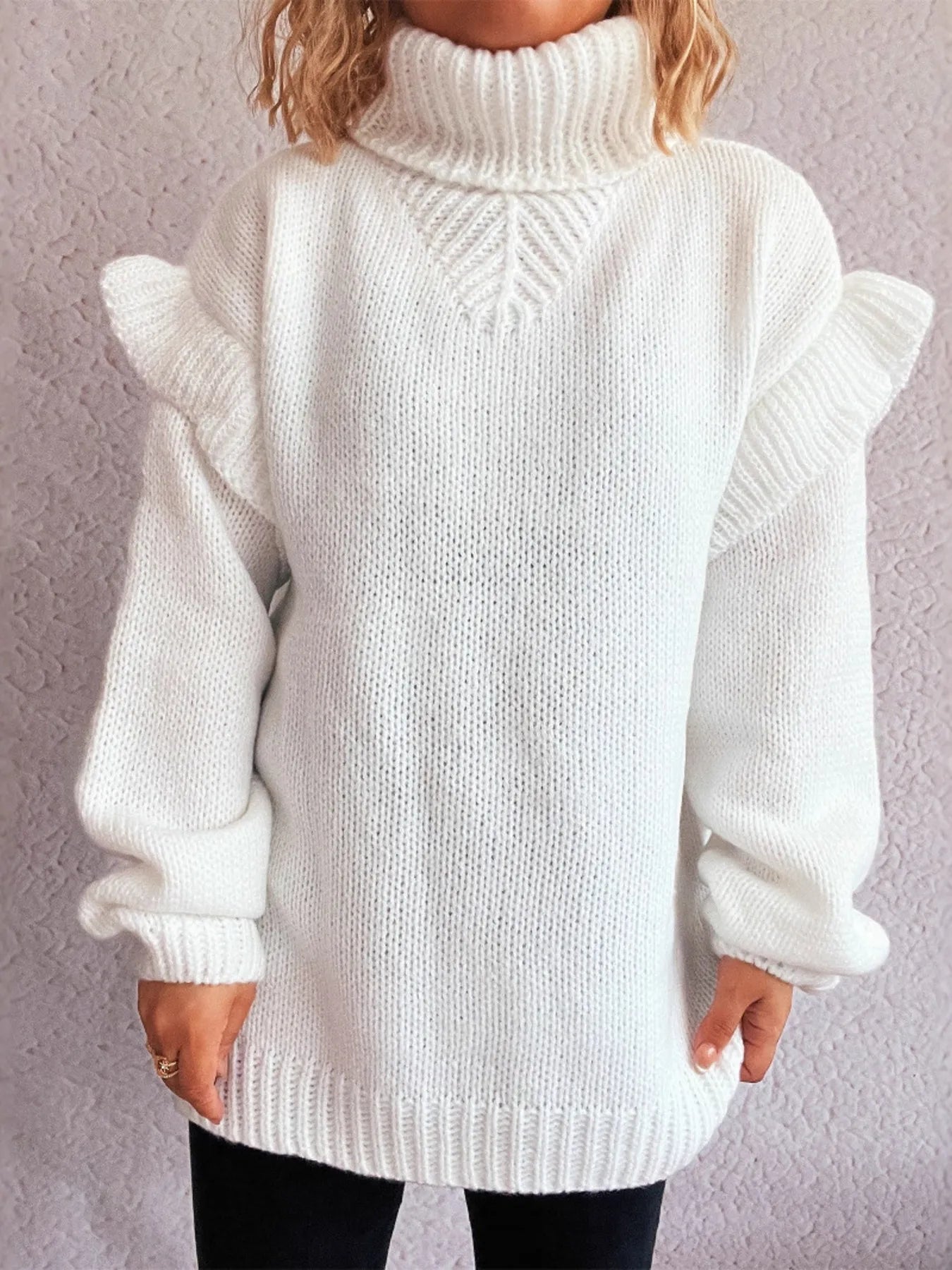 White ruffled turtleneck sweater with long sleeves and wide ribbed cuffs