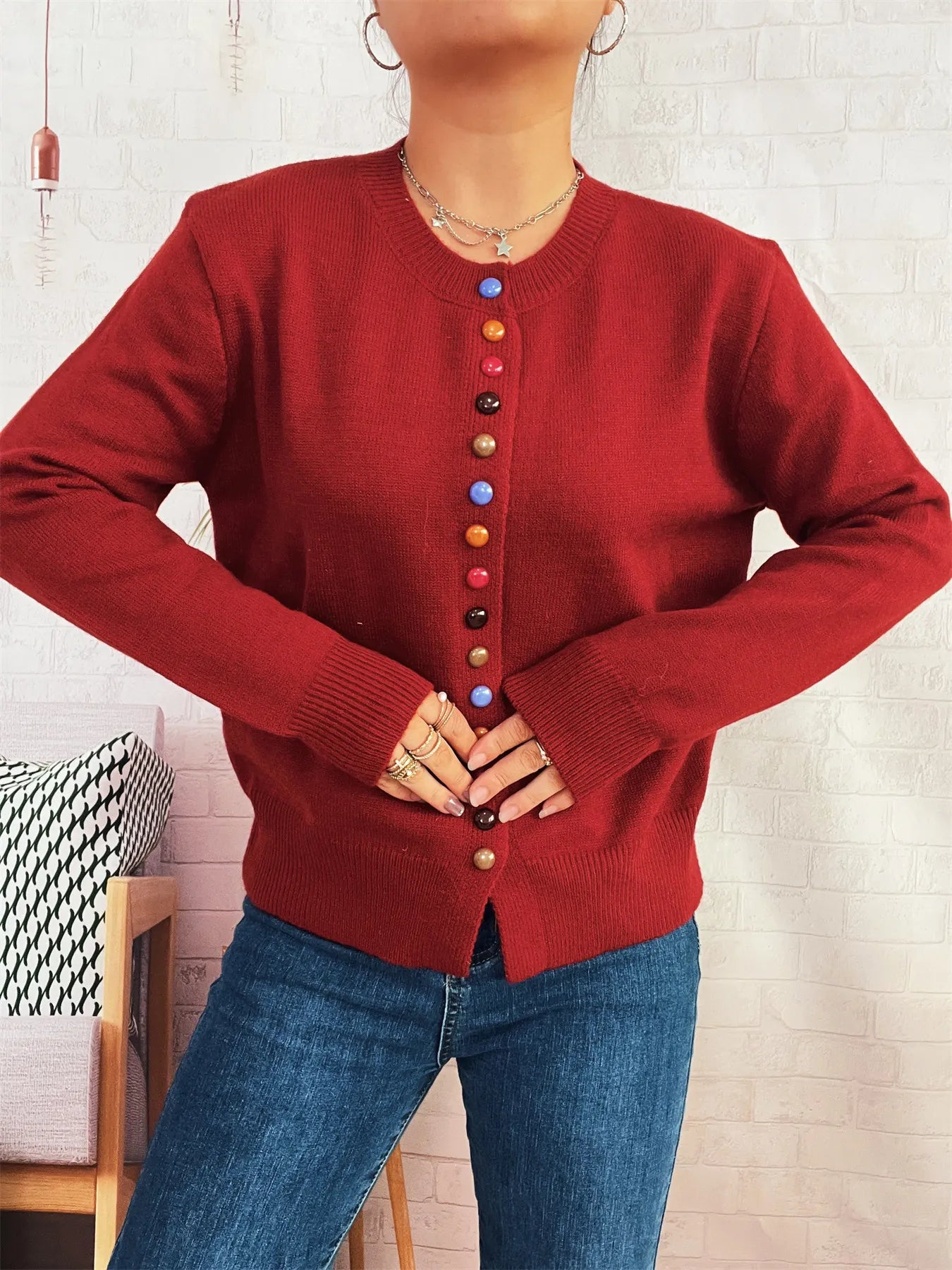 Red button-front cardigan with colorful detail buttons, crew neck, long sleeves