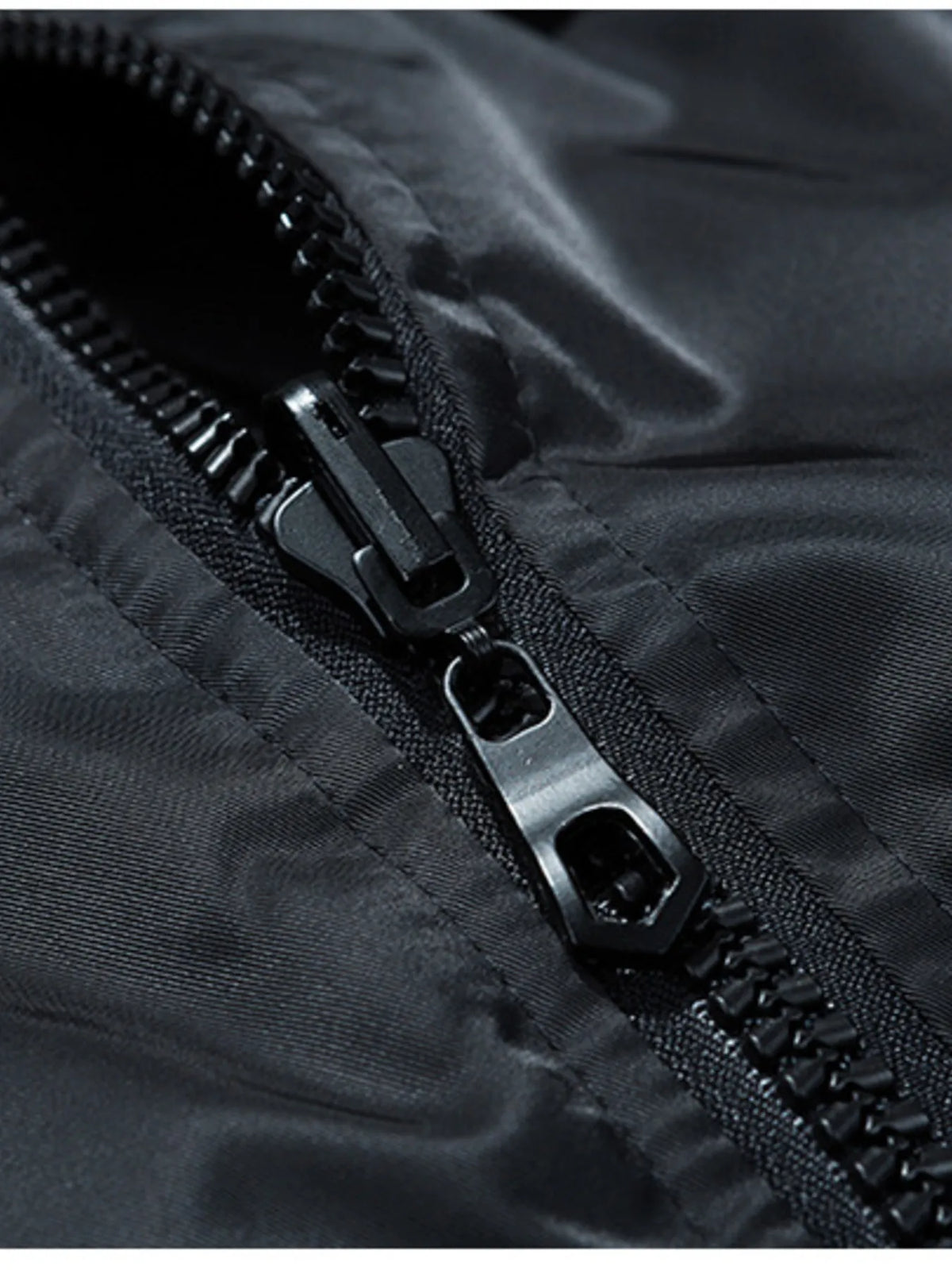 Close-up of black zipper on a bomber jacket with textured fabric