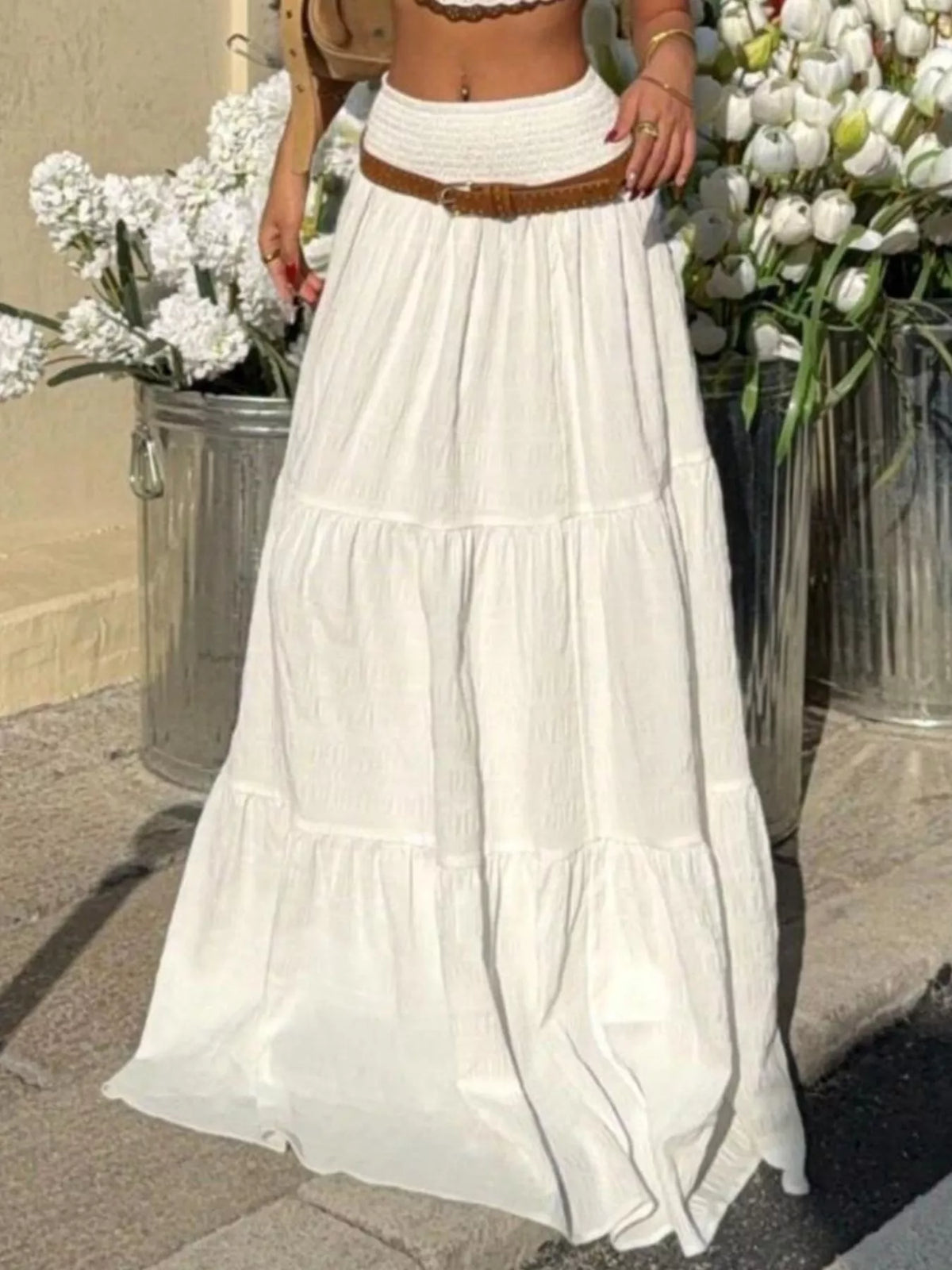 White tiered maxi skirt with smocked waistband and gathered ruffle skirt panels