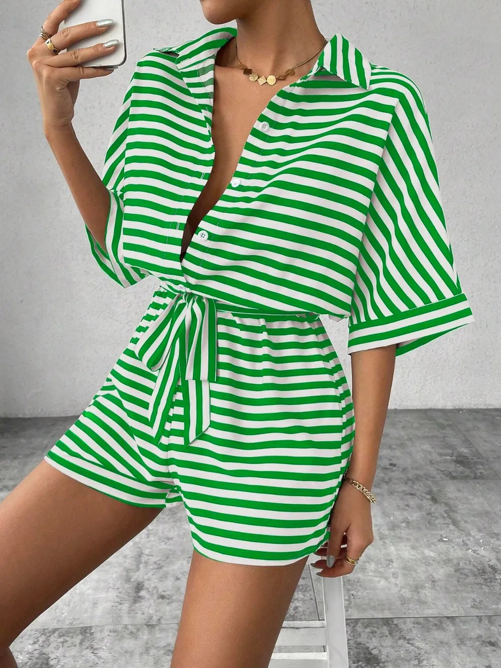 Green-and-white striped tie-waist romper with half-button V-neck and short sleeves
