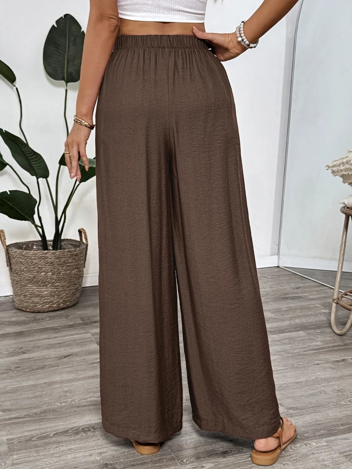 Dark brown wide-leg pants with elastic waist and relaxed wide legs