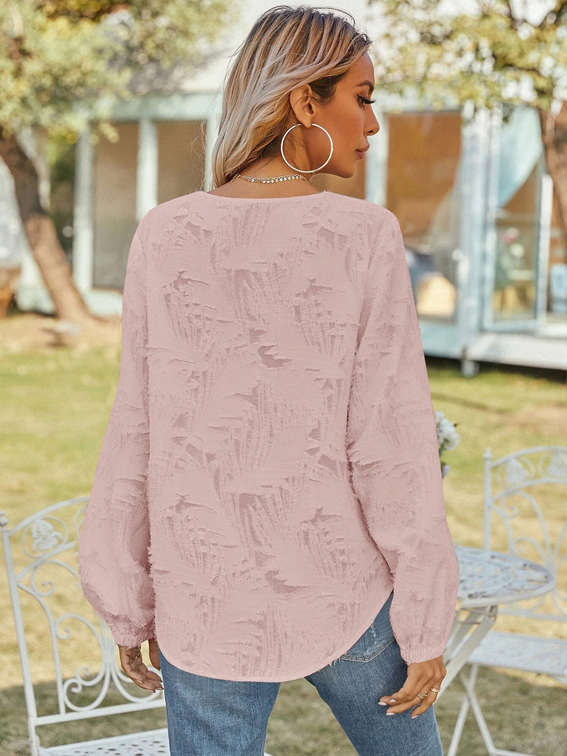 Blush pink V-neck long sleeve blouse with textured back and long puff sleeves