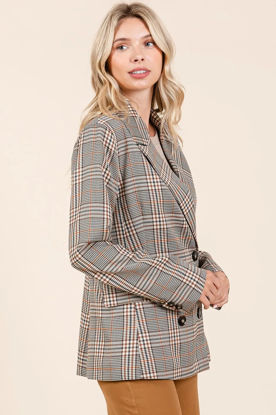 Brown plaid blazer with notched lapels, long sleeves, and double-breasted buttons