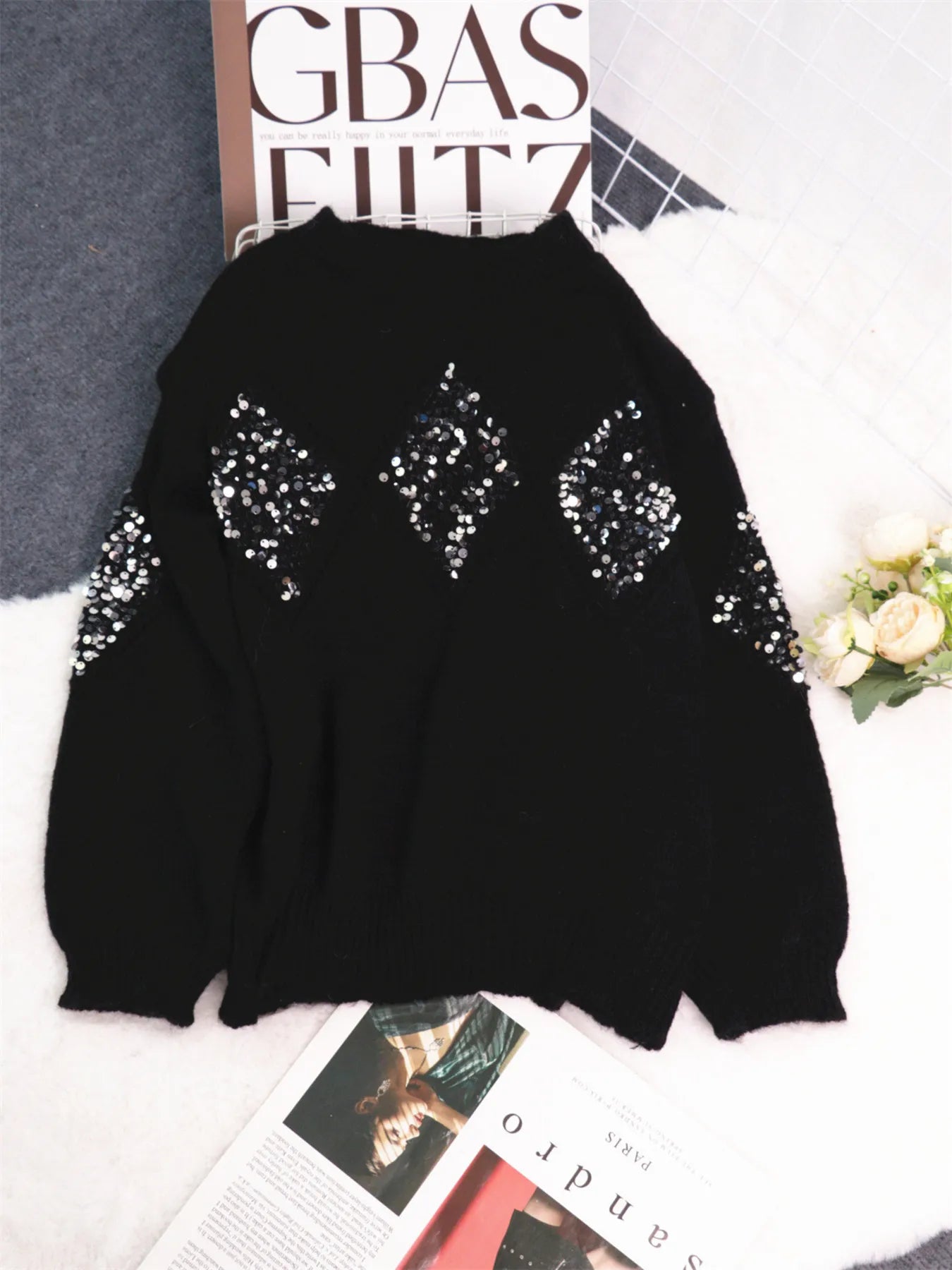 Black oversized sweater flat lay with sequined diamond pattern on front