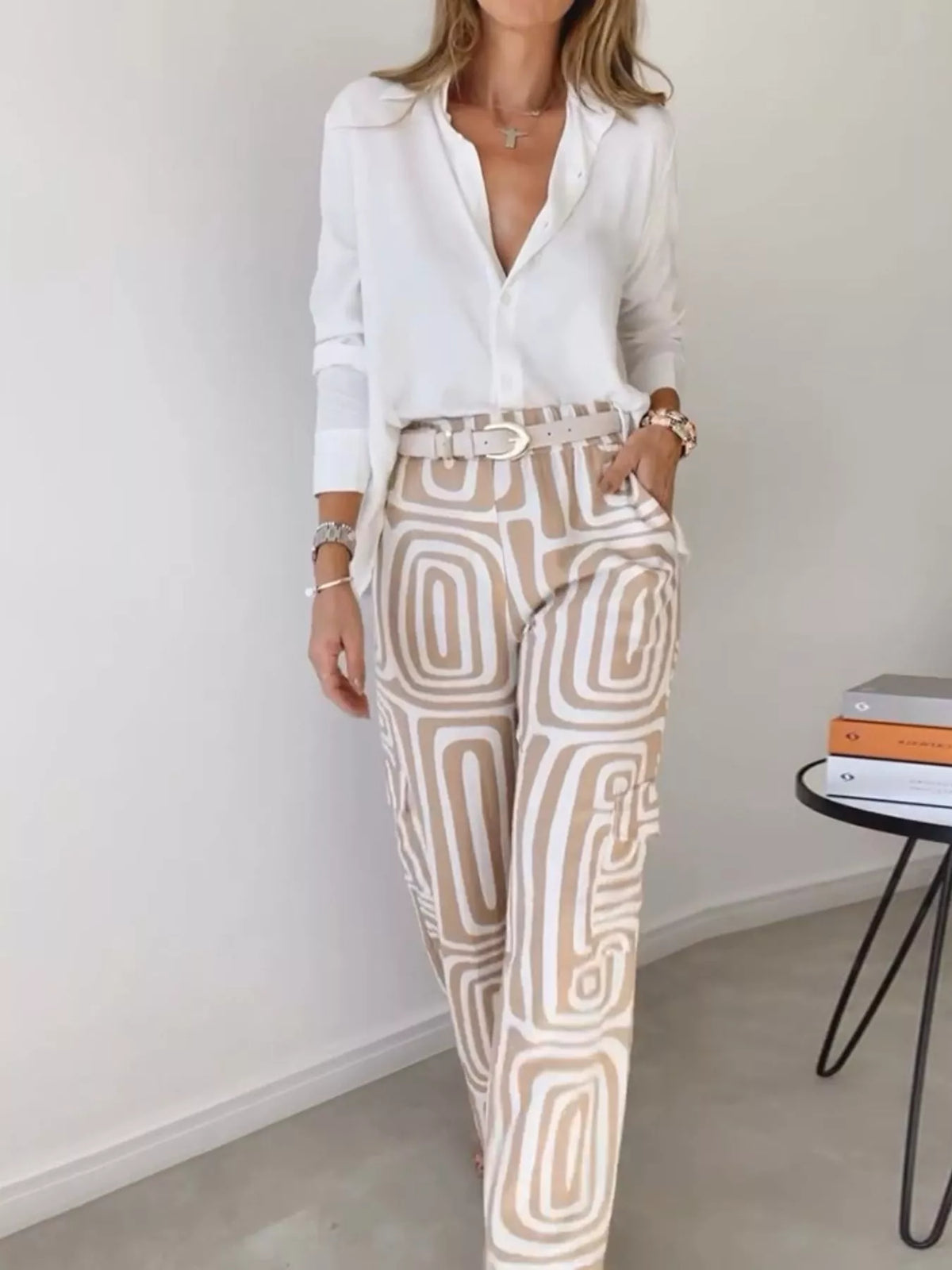 Button-down shirt and geometric patterned pants set with tan and white shapes.