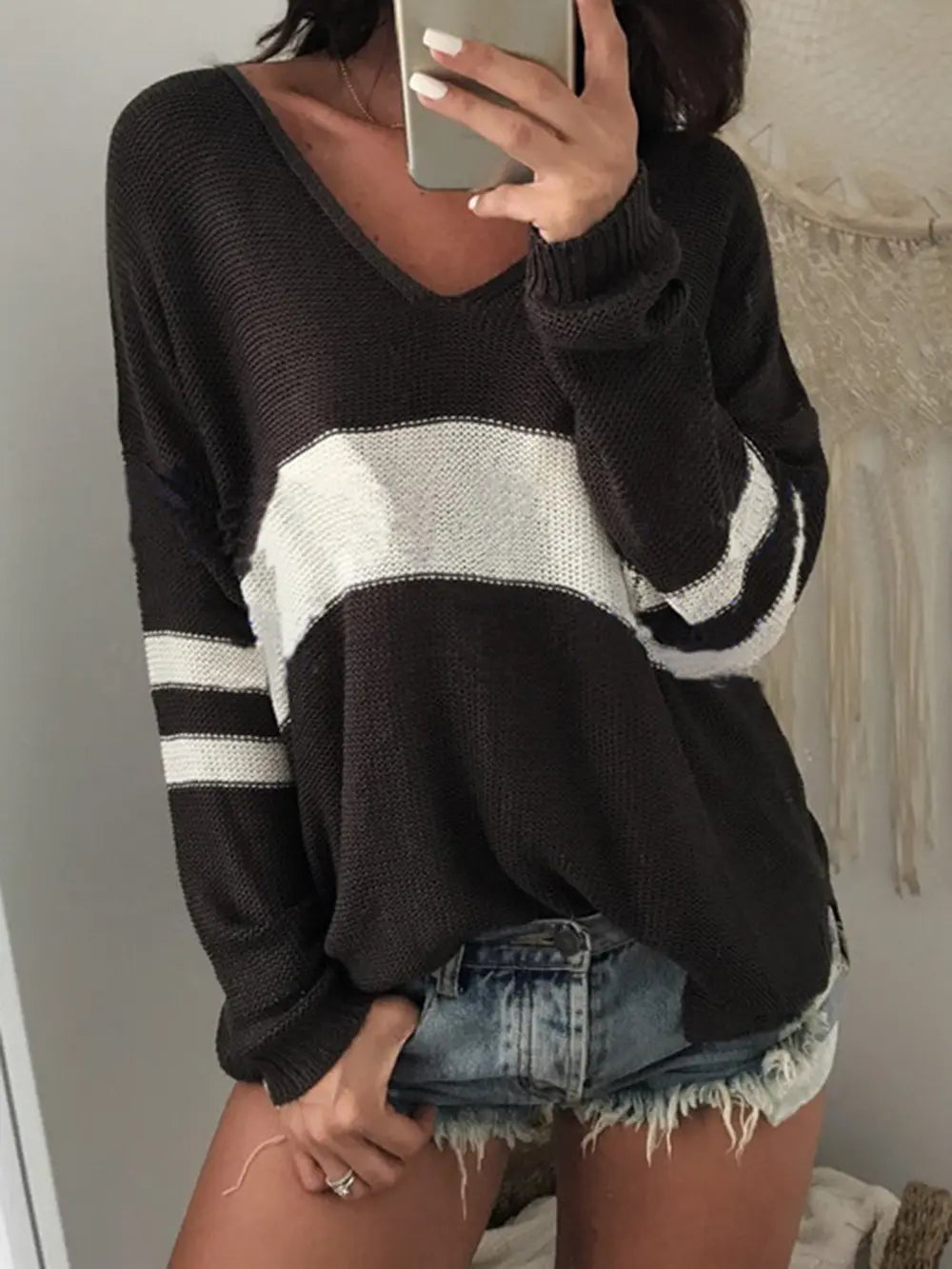 Black V-neck long-sleeve sweater with wide cream stripe and ribbed cuffs