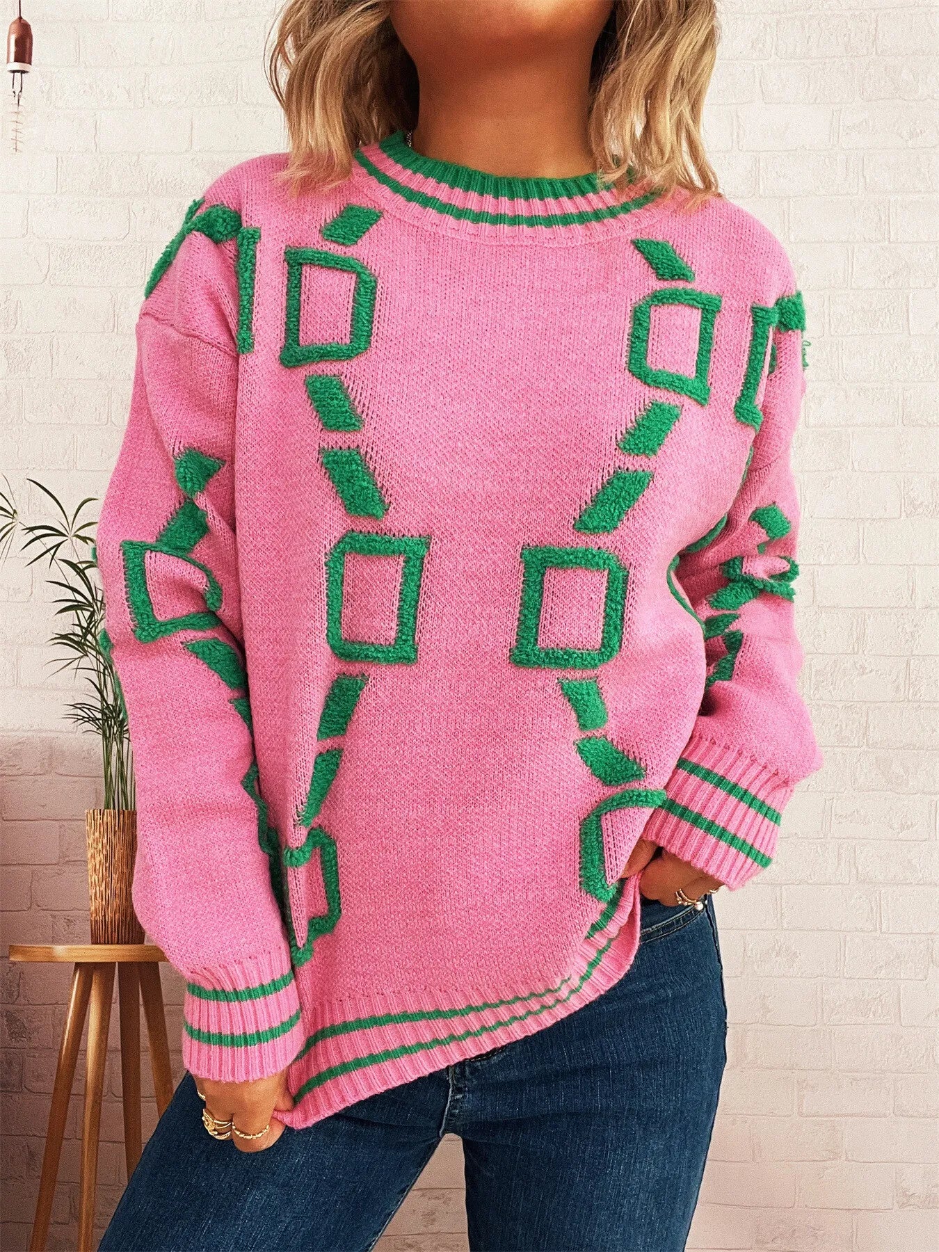Pink long-sleeve sweater with green geometric pattern and ribbed hem and sleeve cuffs