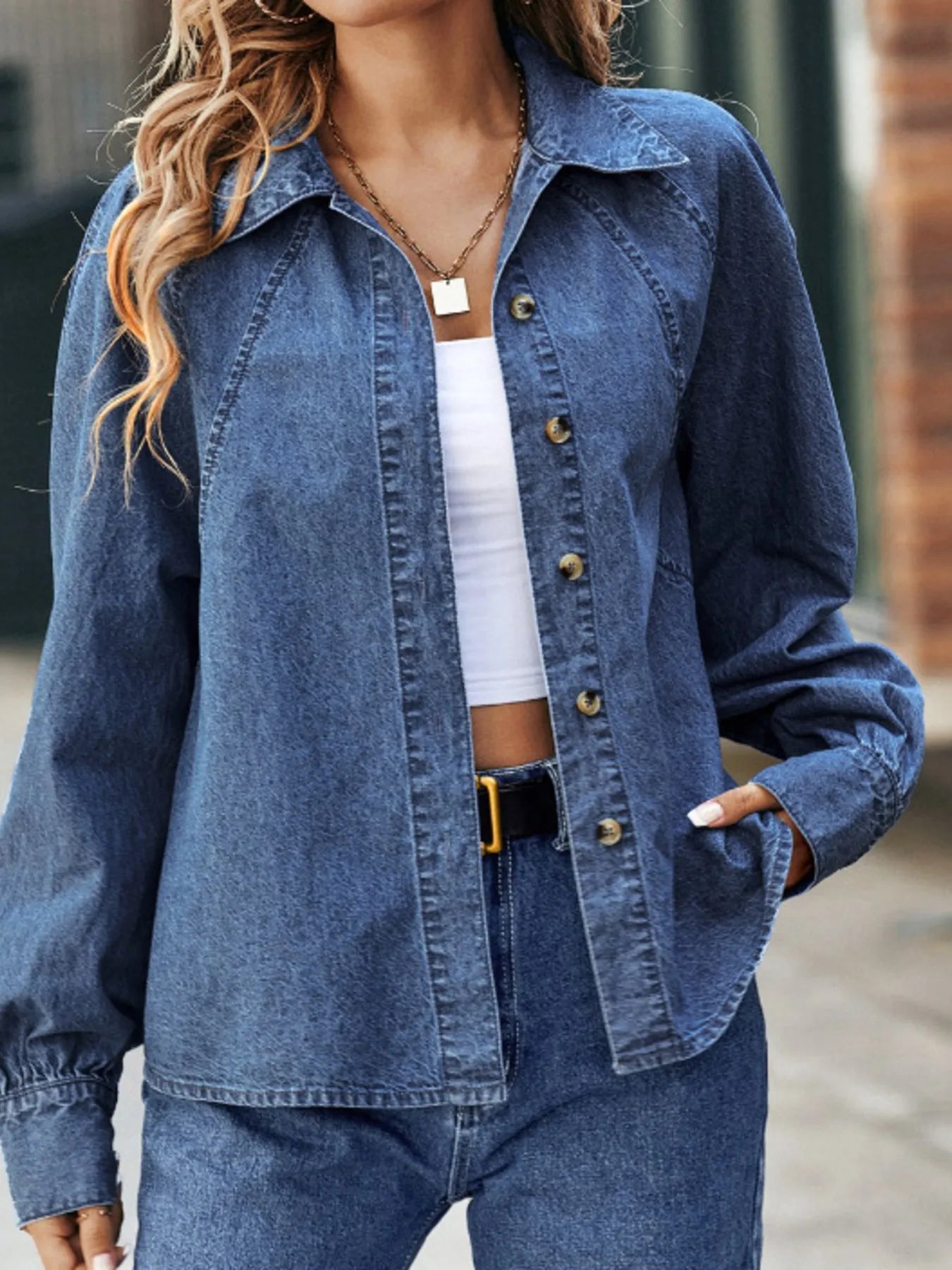 Blue denim button-up long sleeve shirt with pointed collar and front button placket