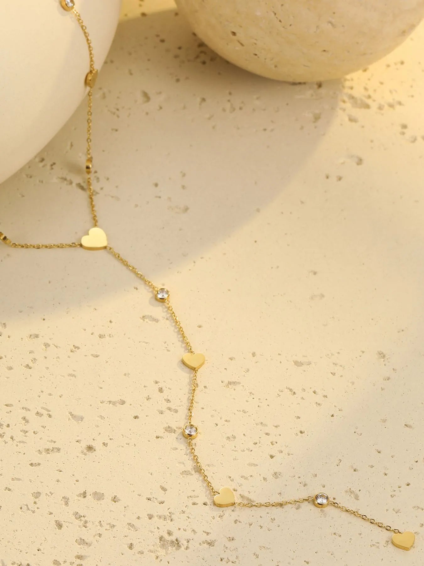 Gold heart zircon necklace with heart charms and round zircon stations