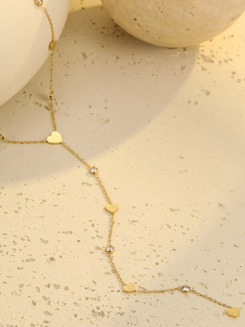 Gold heart zircon necklace with heart charms and round zircon stations
