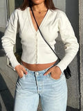 White cropped knit cardigan with V-neck, button front, and long sleeves