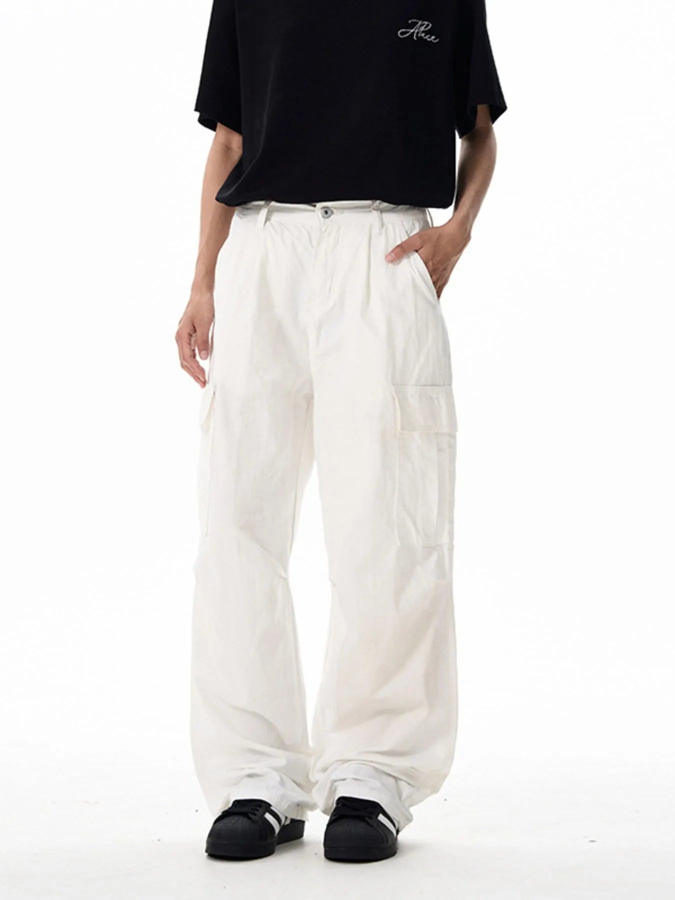 White wide-leg cargo pants with front button closure and side utility pockets