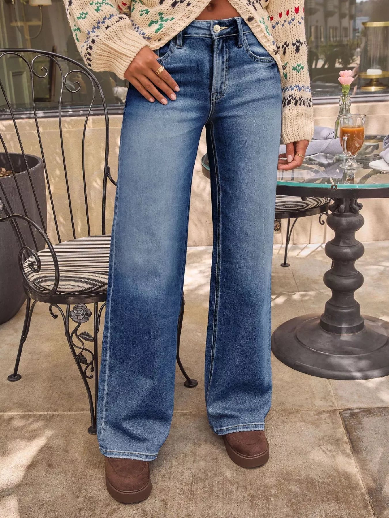 Washed wide-leg jeans in medium blue with belt loops, button fly, and long wide legs