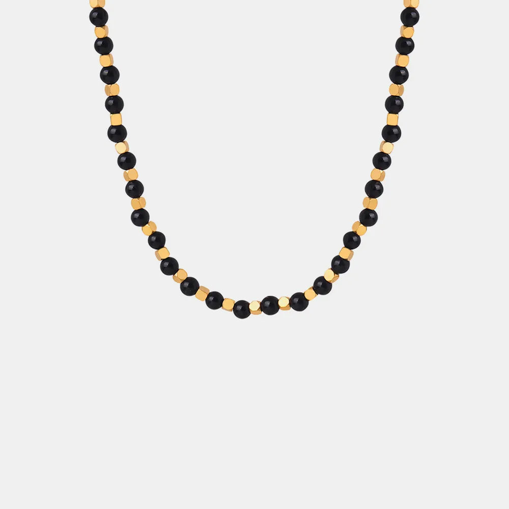 Agate beaded necklace with black beads and gold-tone accents, full front view