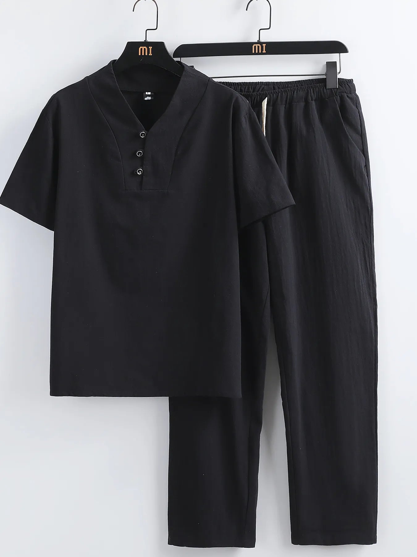 Black V-neck short-sleeve top with button placket and matching elastic-waist pants