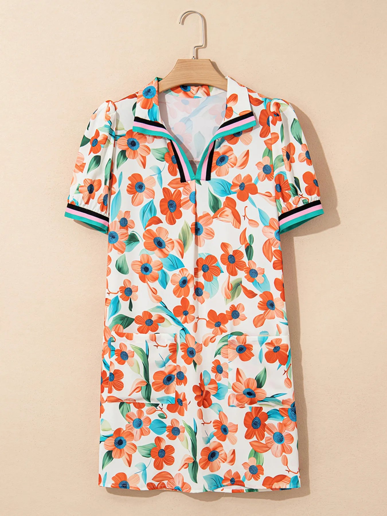 Dress: floral print with orange flowers and teal leaves, split-neck with contrast trim on collar and cuffs, puff sleeves