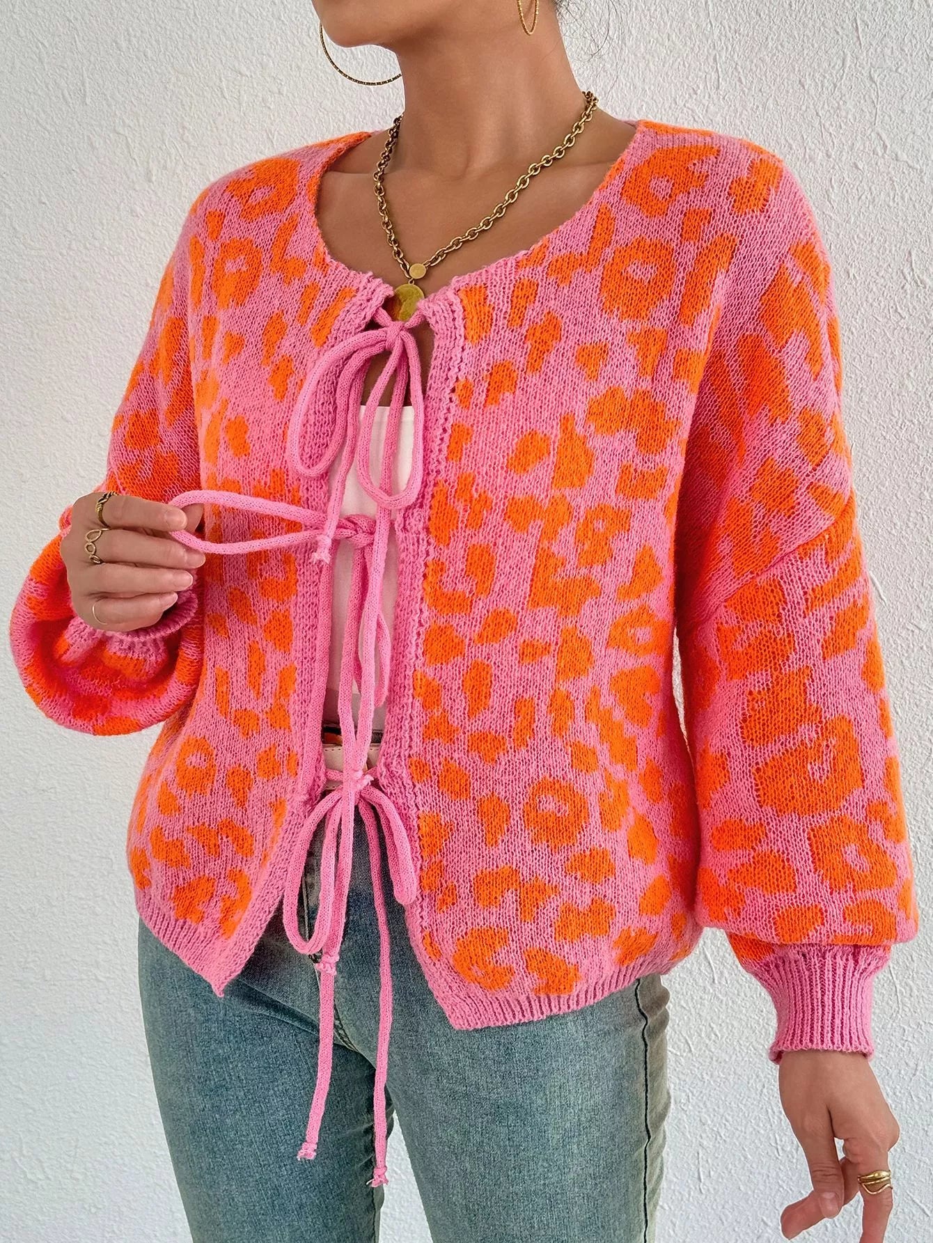 Leopard tie-front cardigan in orange knit with pink drawstring and balloon sleeves