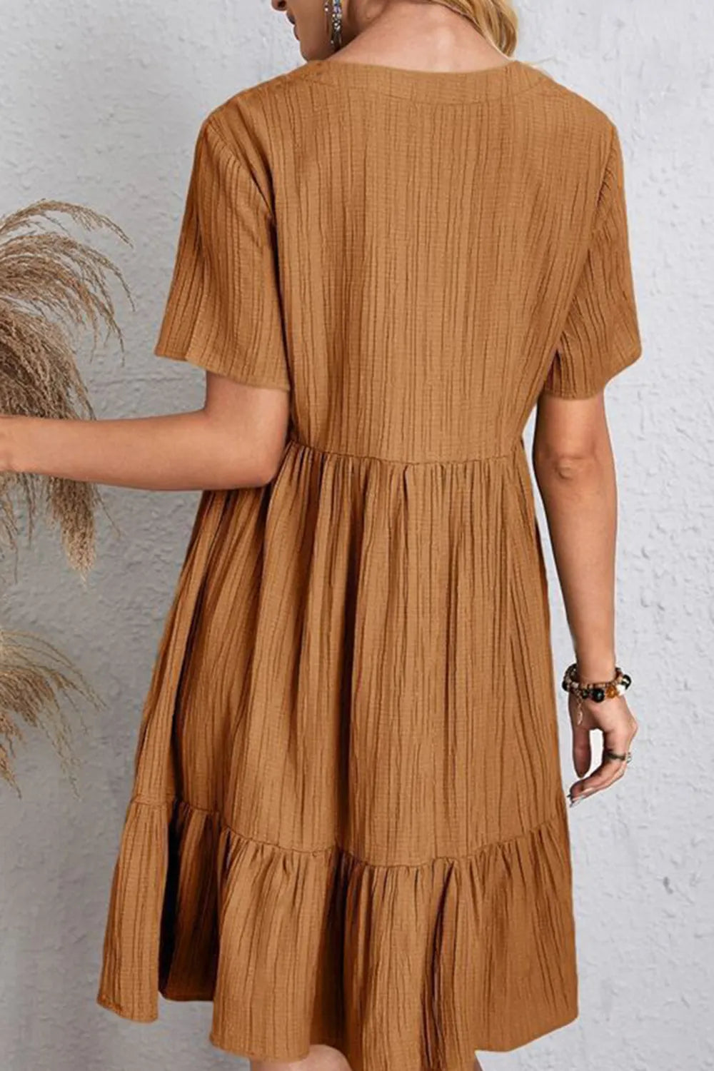 Caramel V-neck short-sleeve dress, back view, gathered waist and tiered hem