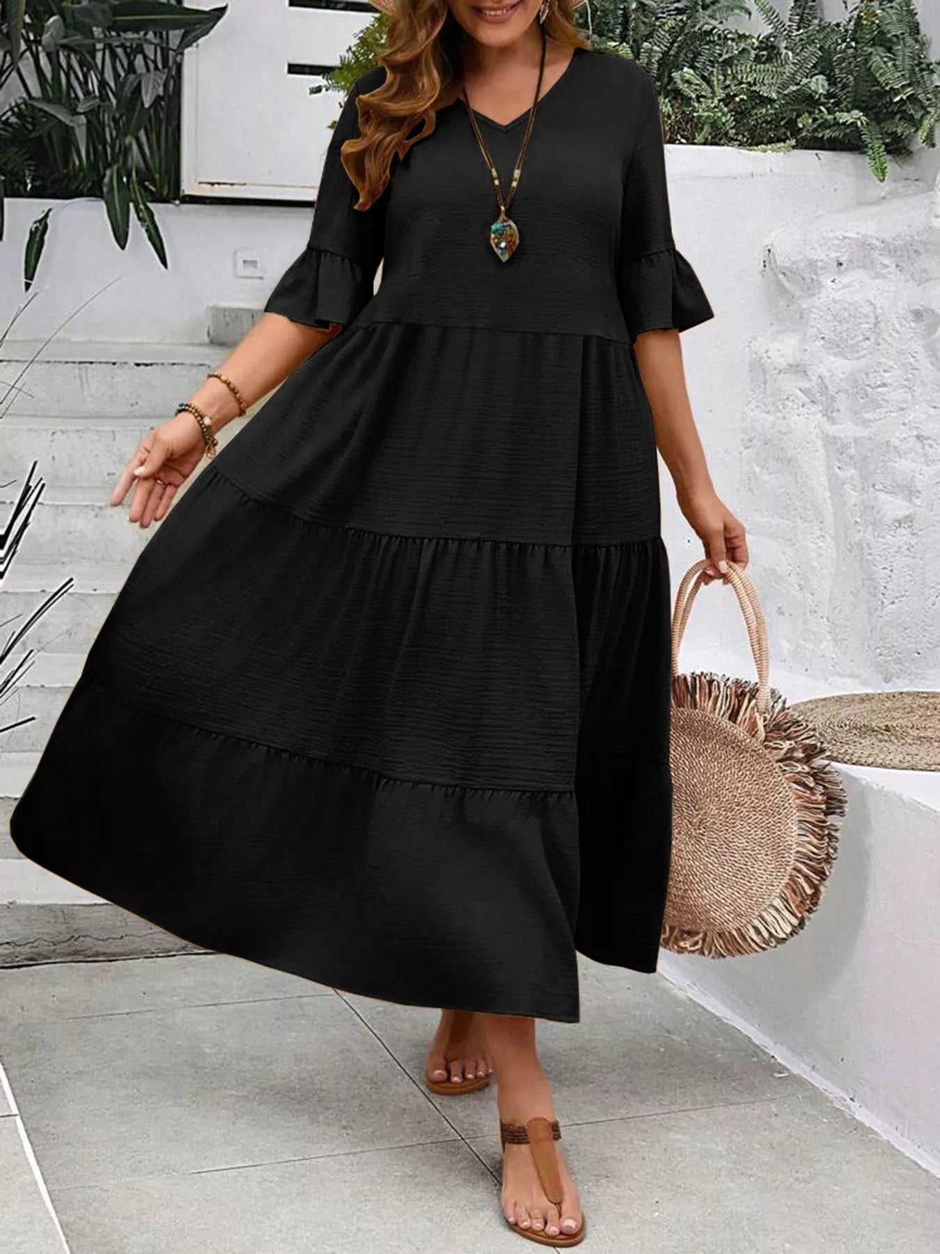 Black tiered midi dress with ruffle sleeves and full skirt tiering, V-neck
