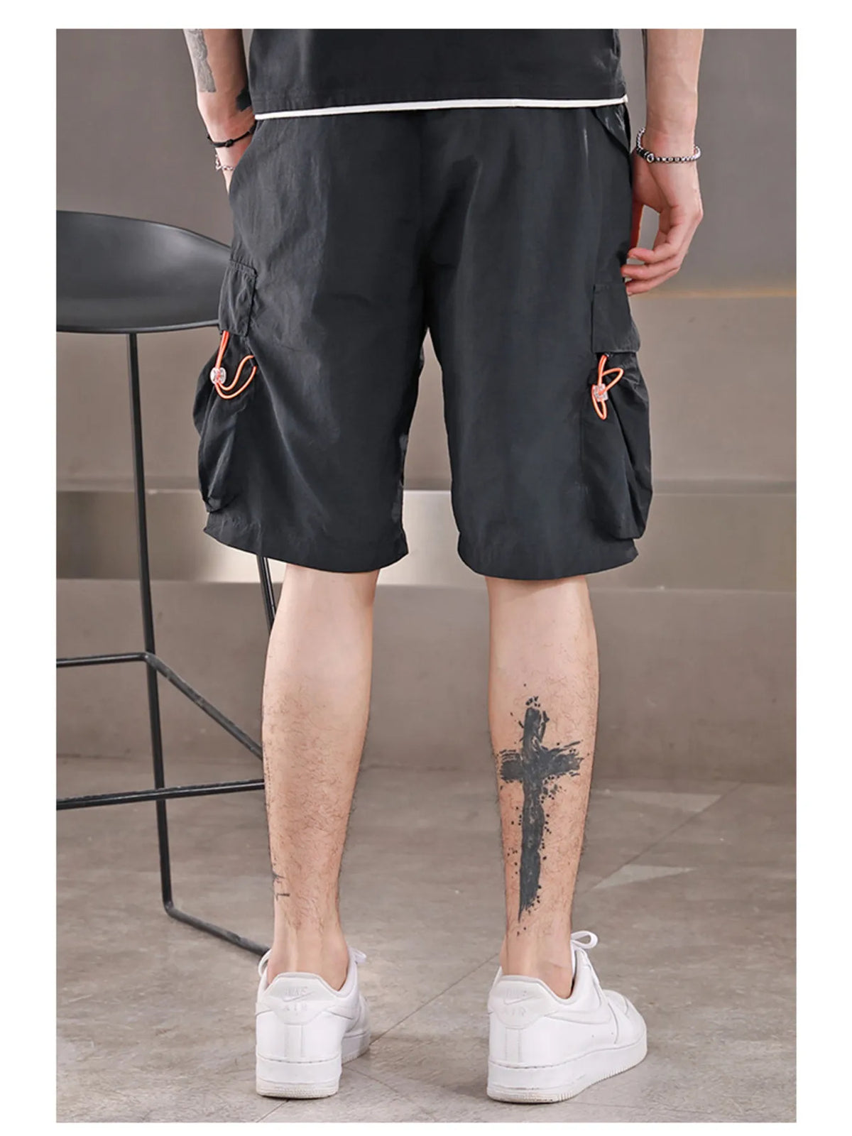 Men's black nylon cargo shorts with drawstring and utility pockets
