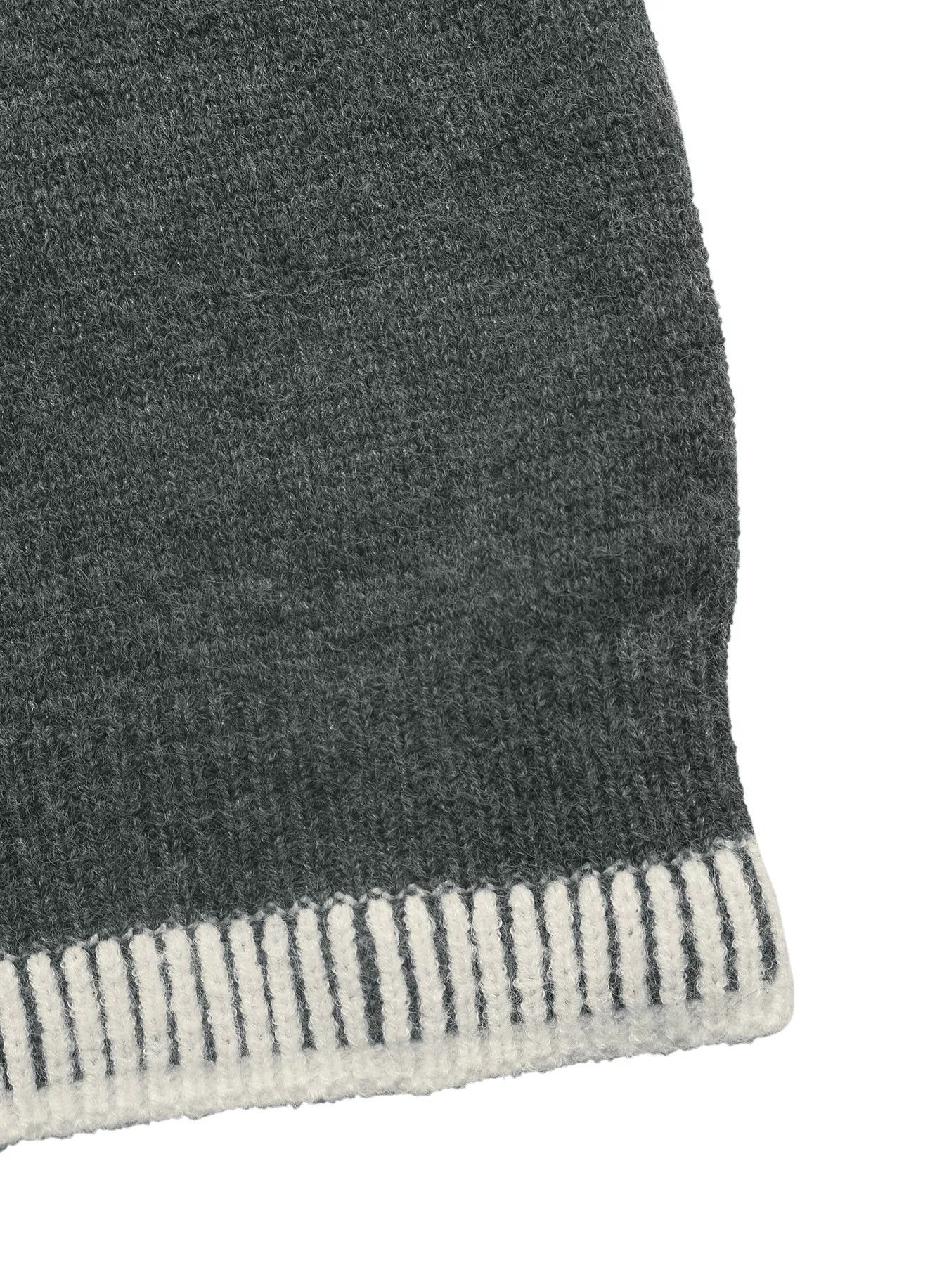 Dark gray sweater hem with white ribbed striped trim