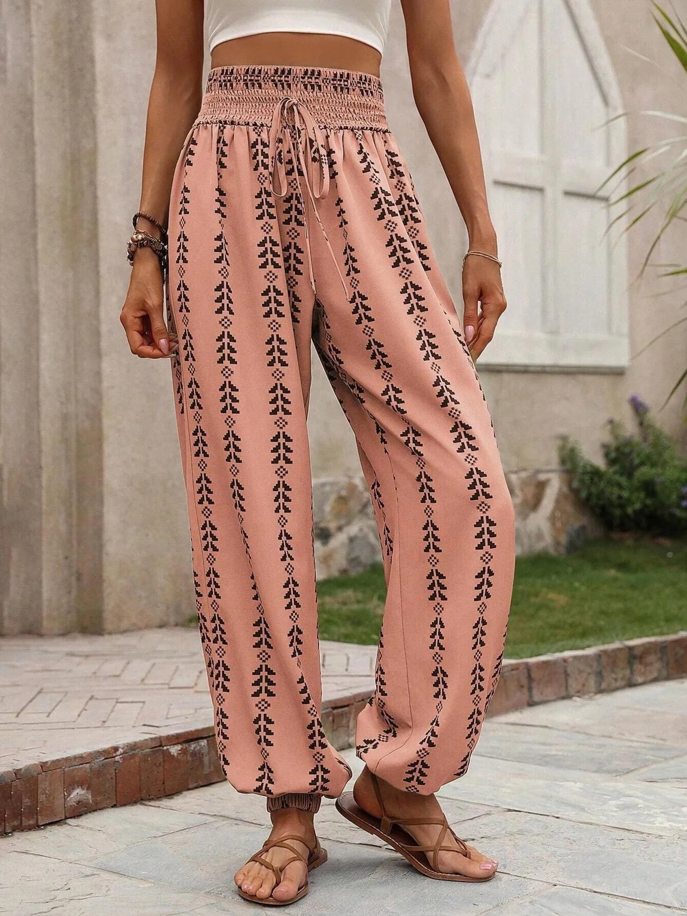 Wide-leg printed pants, pale blush with black vertical motif and elastic waistband