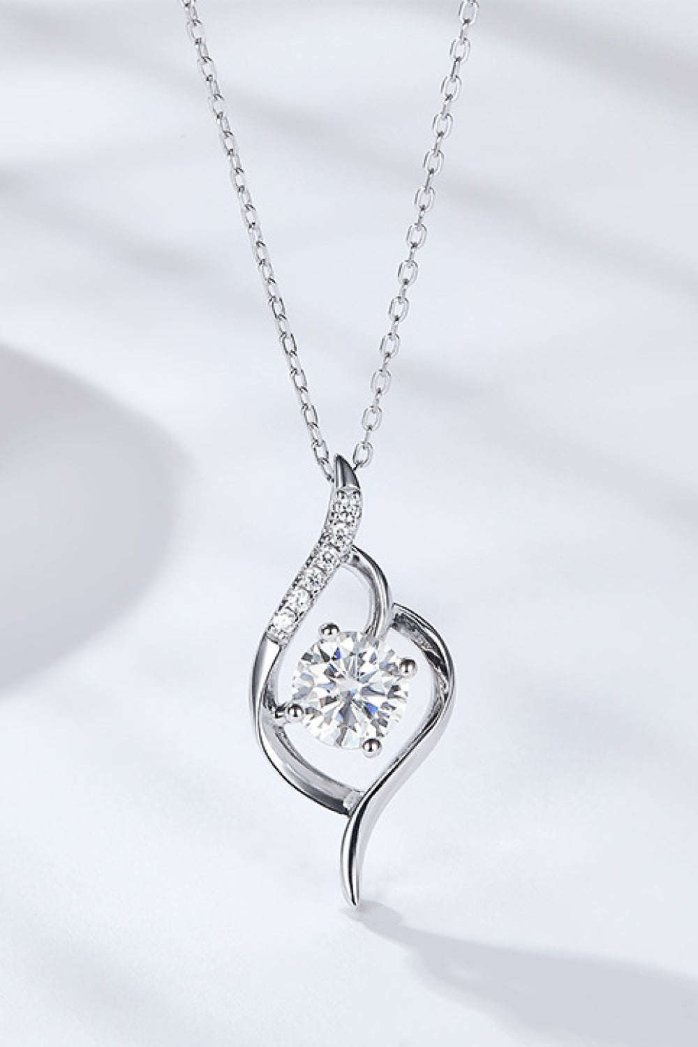 Silver moissanite pendant necklace with teardrop heart pendant and round stones on chain
