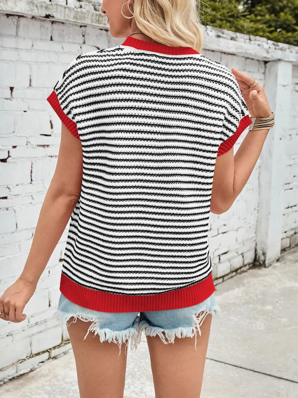 Striped cap-sleeve sweater back view, black-and-white stripes with red trim