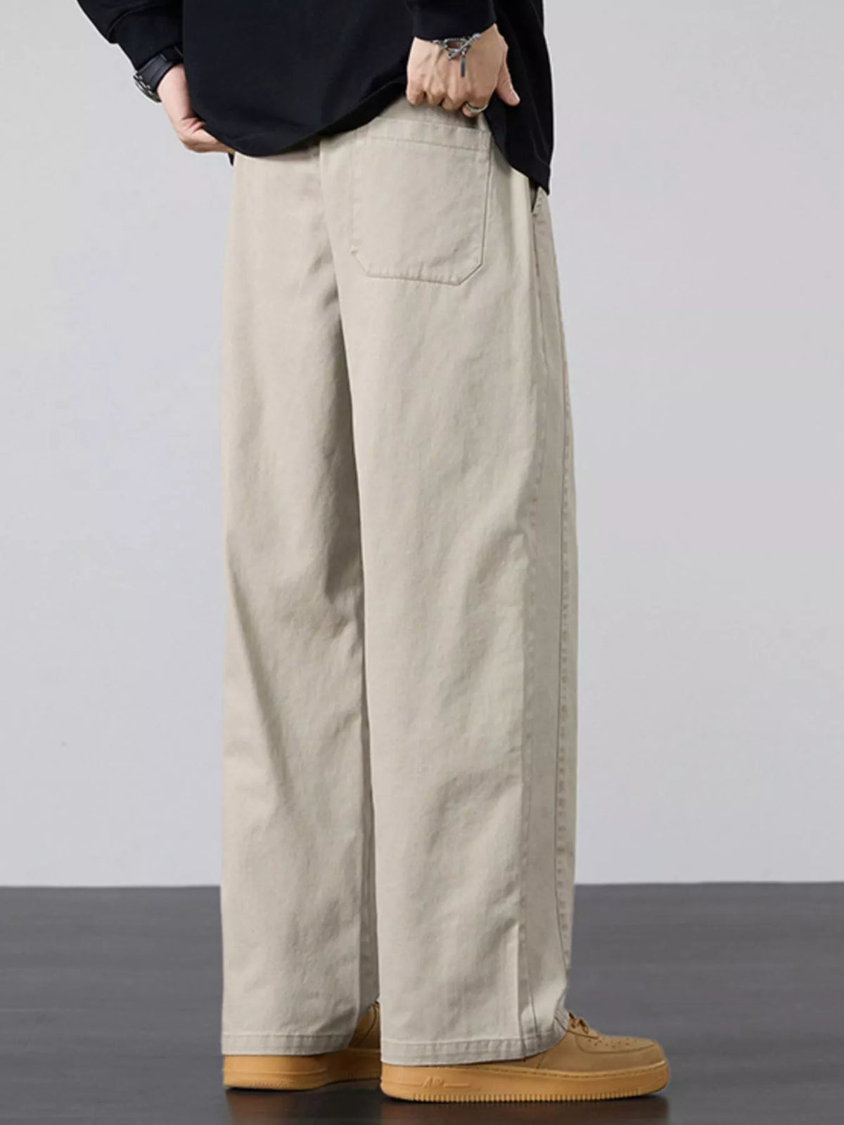 Men's wide-leg drawstring casual pants, light khaki with front pockets and cuffed hem.