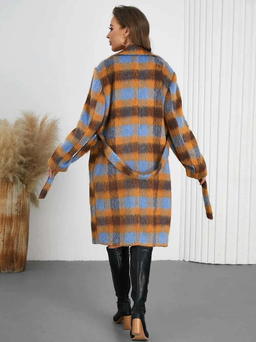 Back view of plaid collared neck coat with waist tie belt and long sleeves.