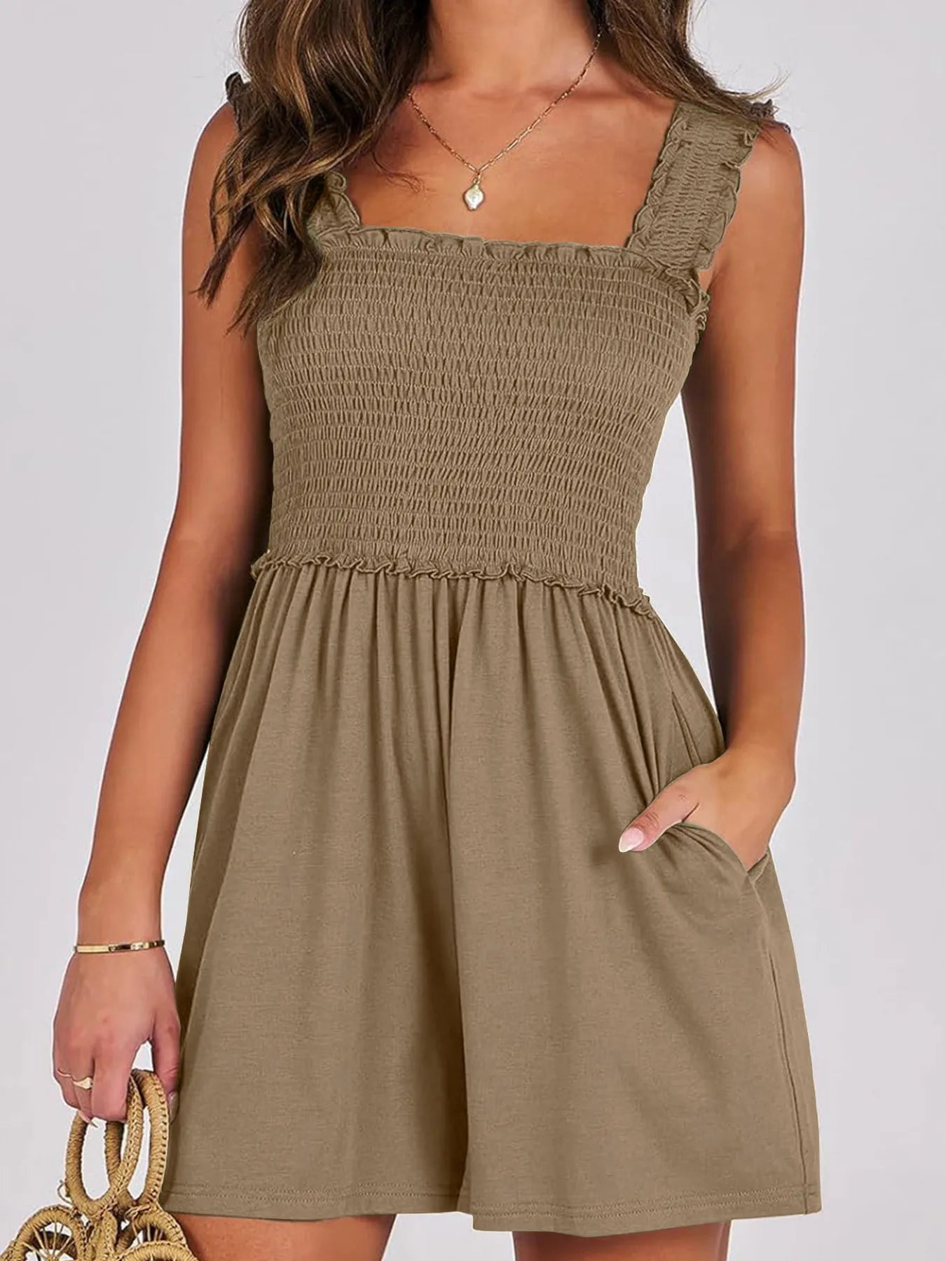 Smocked square-neck sleeveless romper, dark olive green, gathered waist, short skirt.