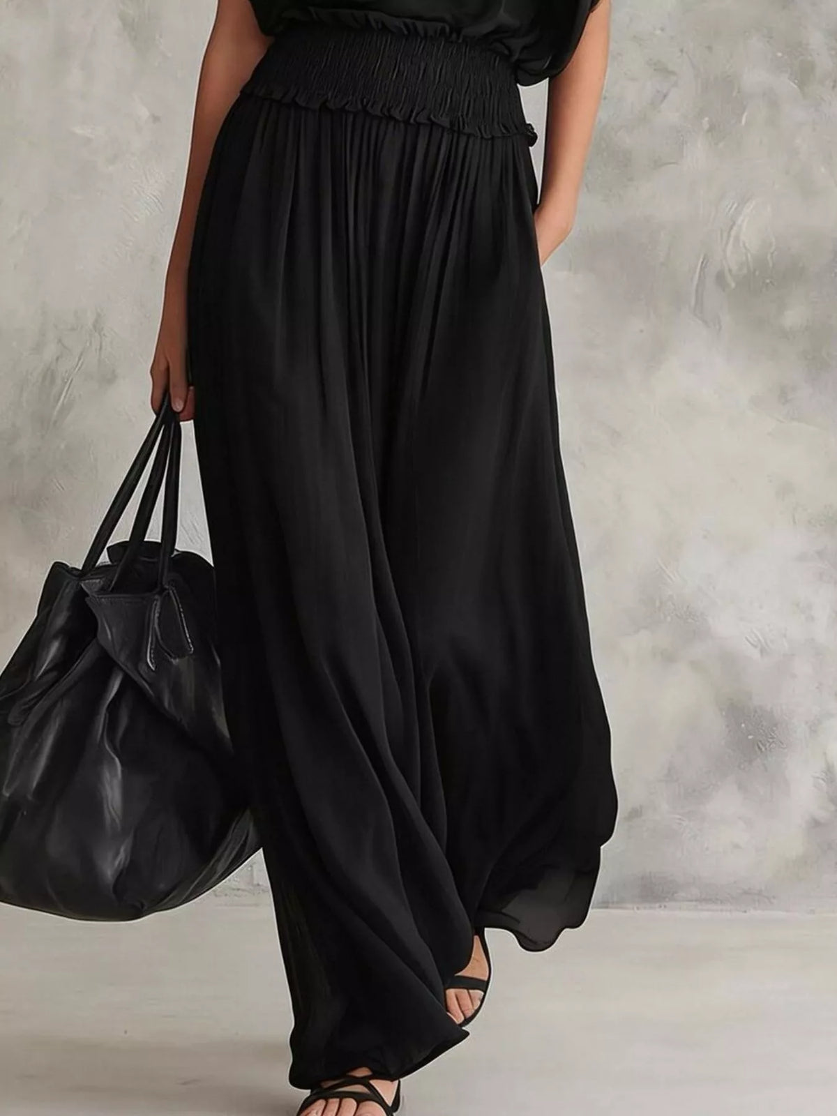 Black chiffon maxi dress with smocked waist and flowing wide skirt