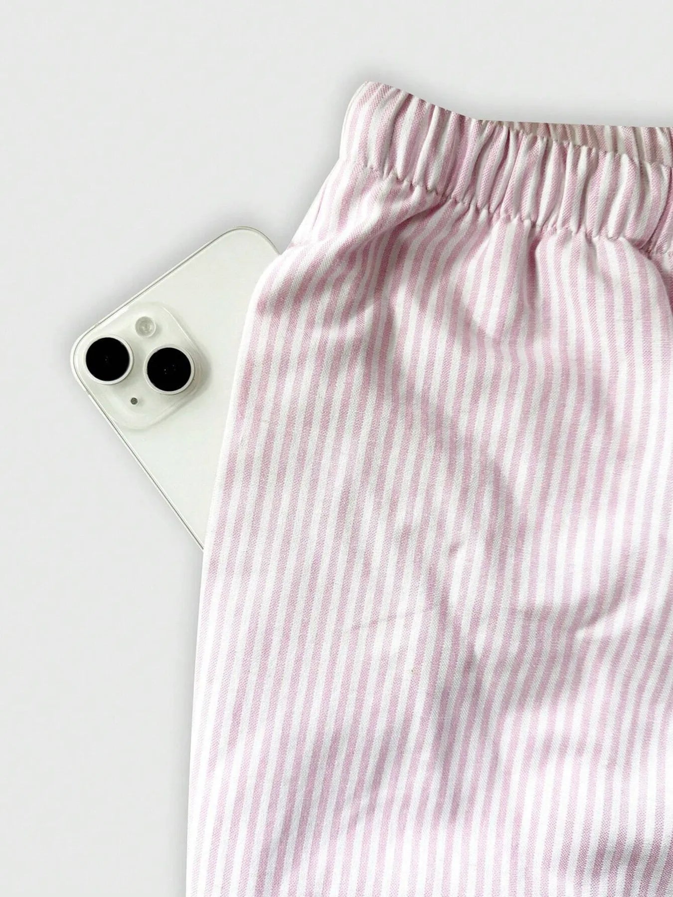 Light pink striped pants waistband with elastic band and drawstring tie cords