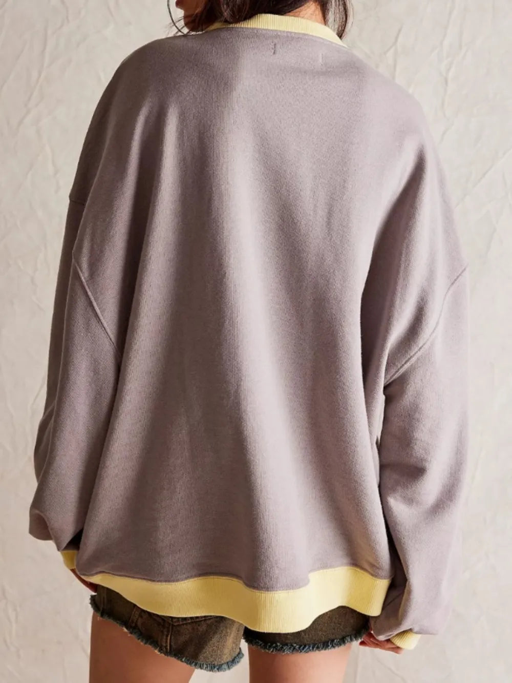 Gray long-sleeve sweatshirt with yellow contrast hem and neckline trim, back view