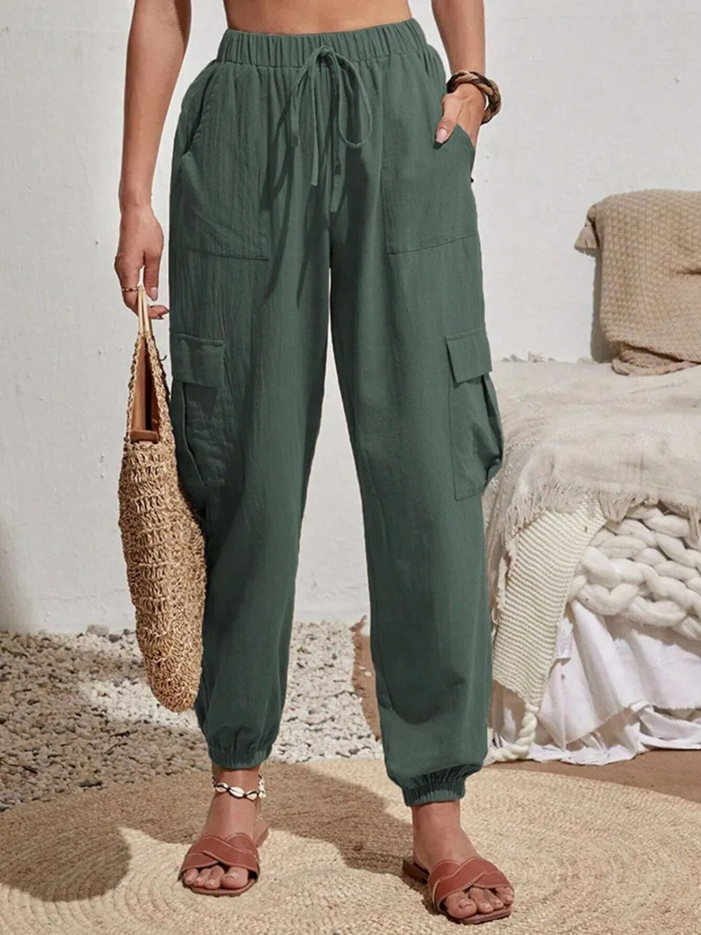 Dark green drawstring cargo joggers with side cargo pockets and elastic ankle cuffs