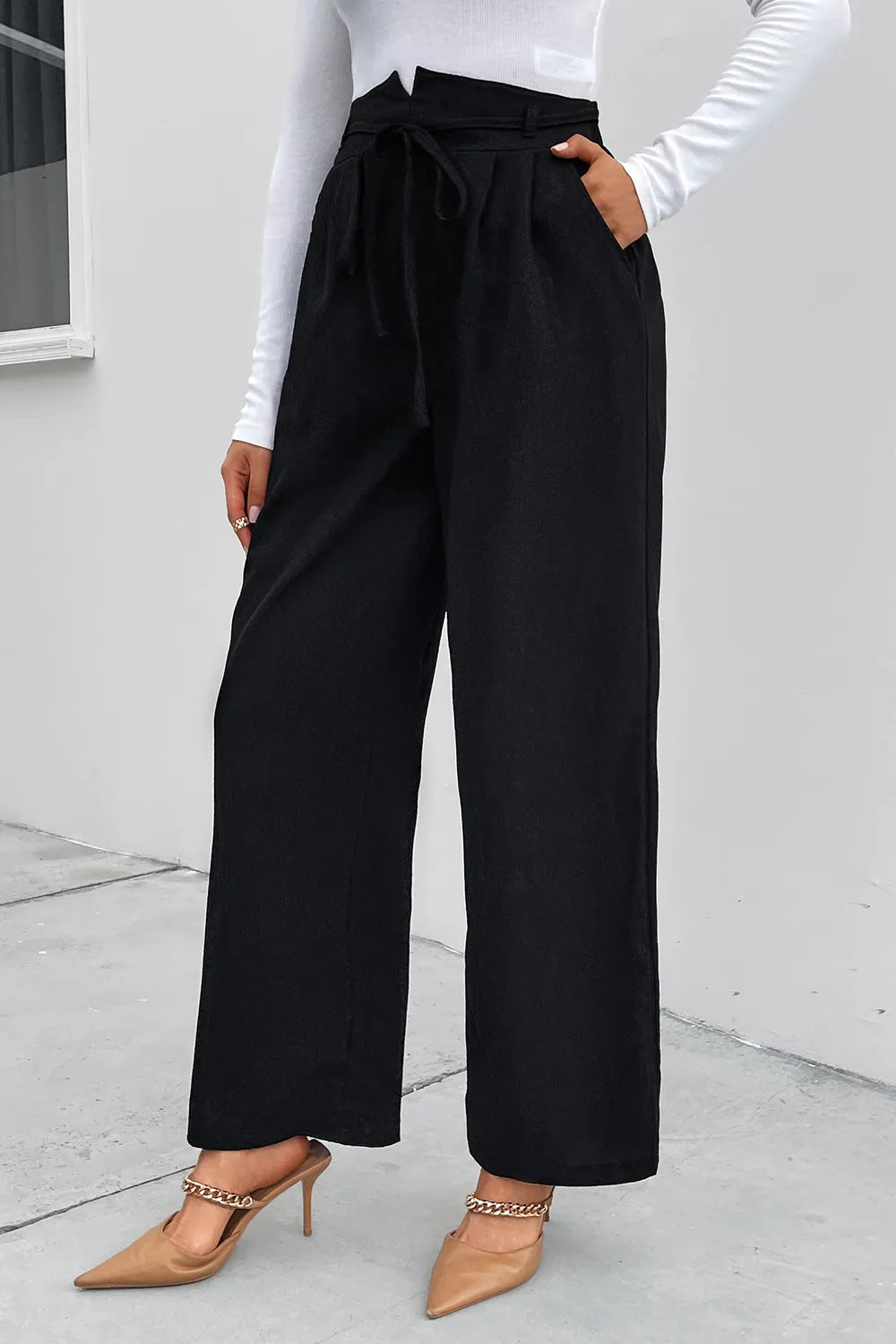 Black high-waist wide-leg pants with tie-front detail, side view