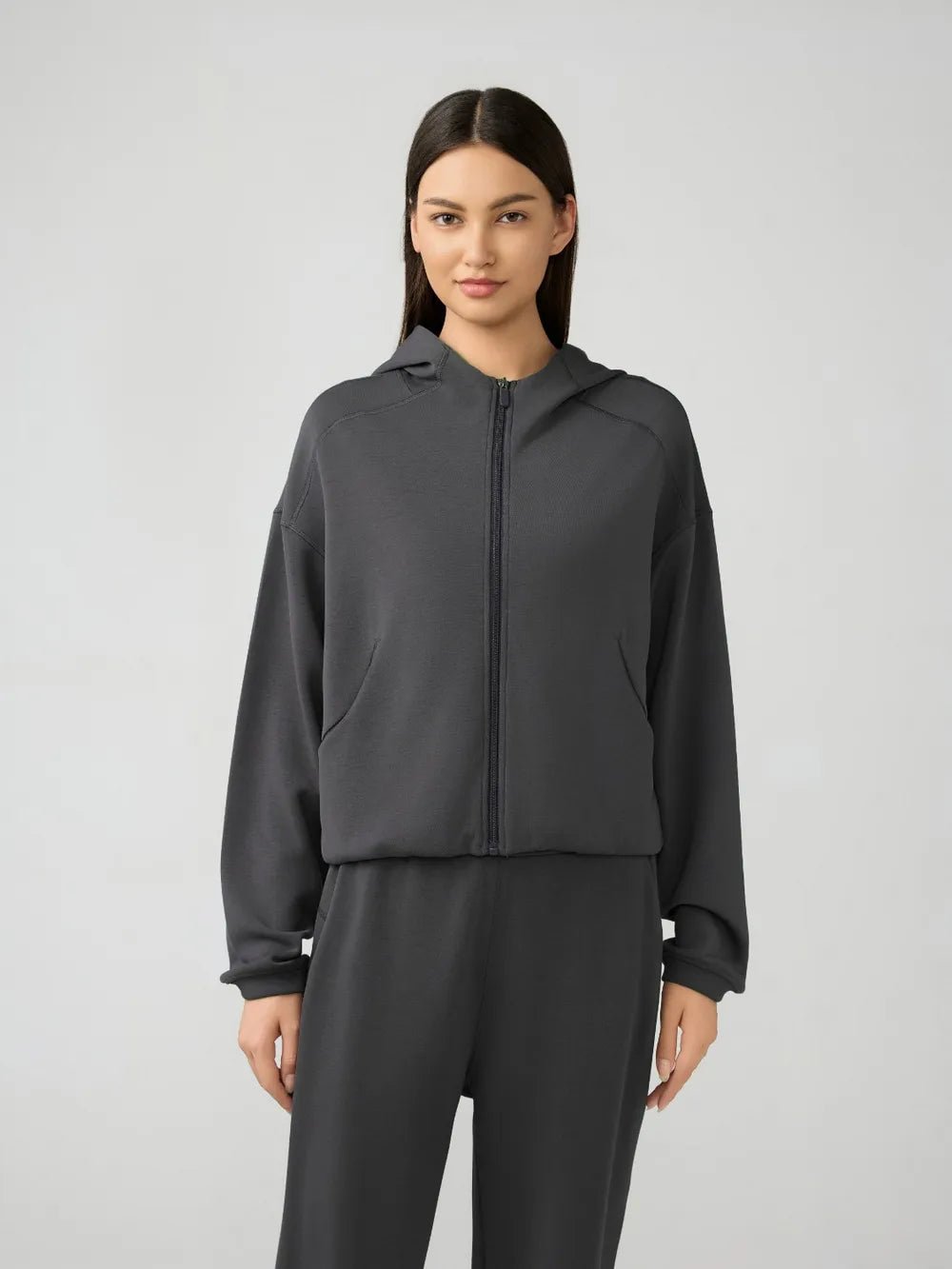 Dark gray zip-up hooded active jacket with dropped shoulders and long sleeves
