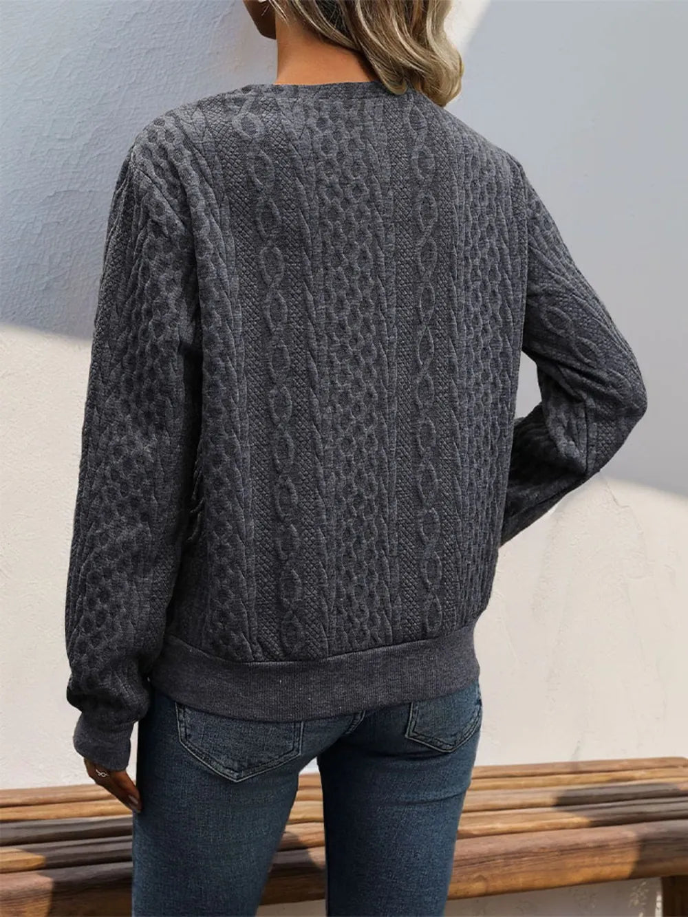 Dark gray long sleeve sweatshirt with cable-knit pattern and relaxed back yoke