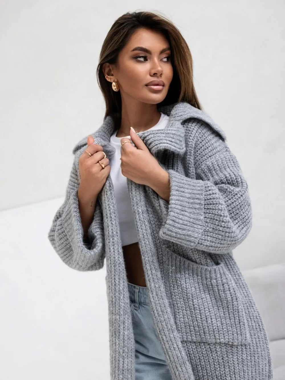 Gray collared knit cardigan with dropped shoulders and side pockets, front detail