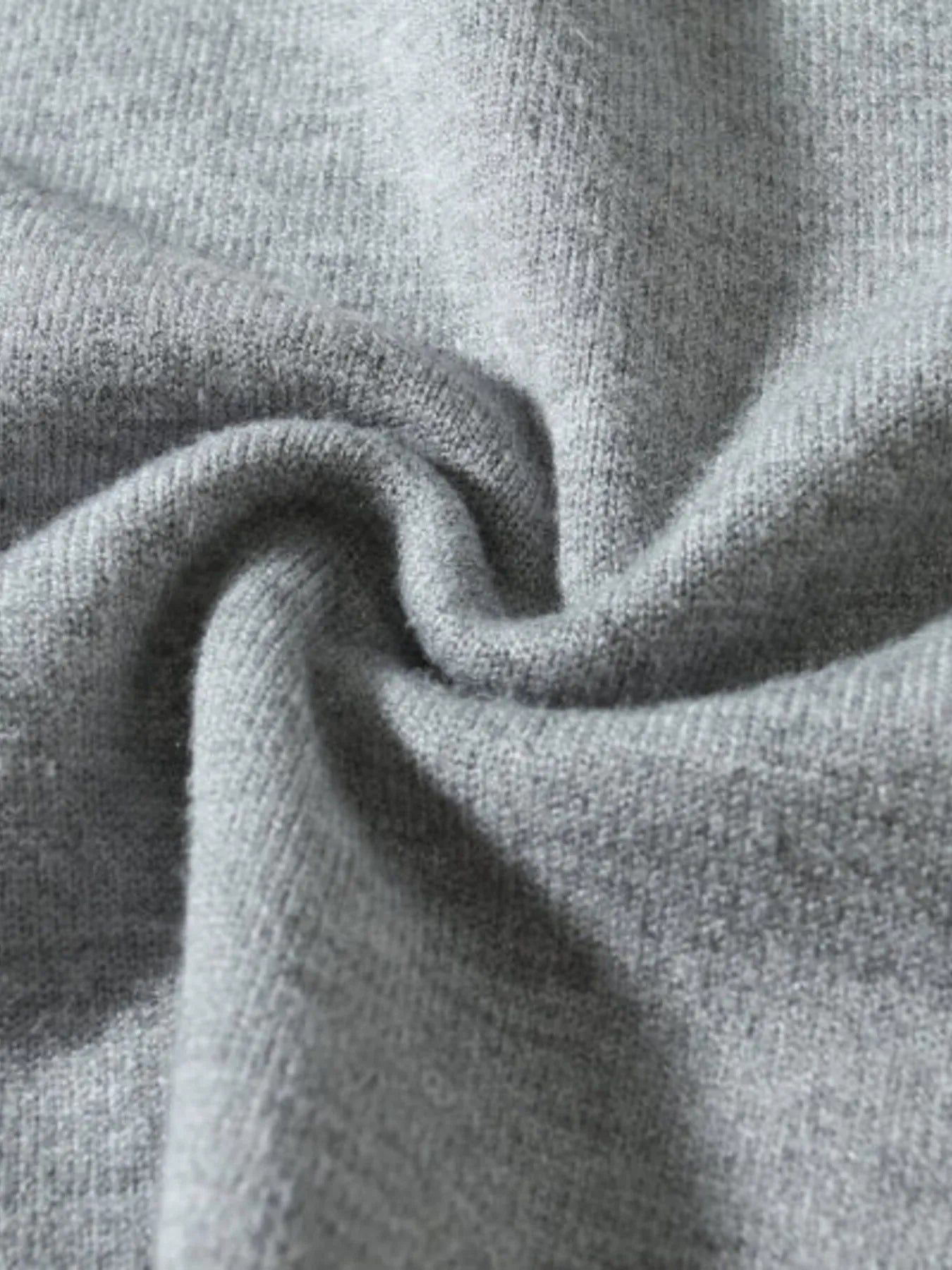 Men's long-sleeve ribbed-hem sweater fabric close-up, gray heather knit
