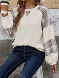 Cream sweatshirt with plaid raglan sleeves, round neckline and keyhole cutout