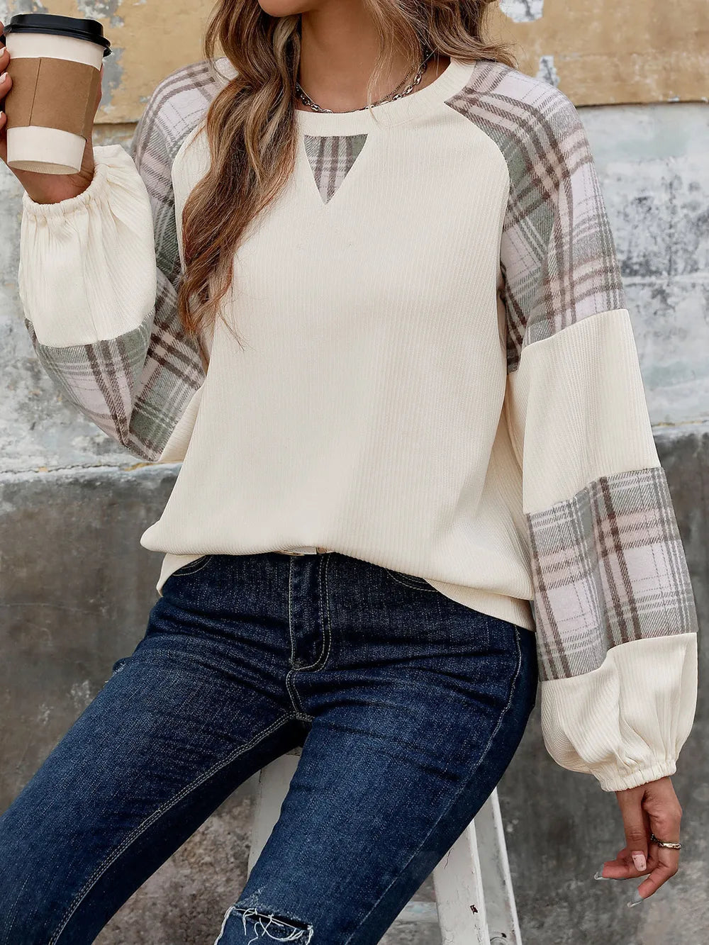 Cream sweatshirt with plaid raglan sleeves, round neckline and keyhole cutout