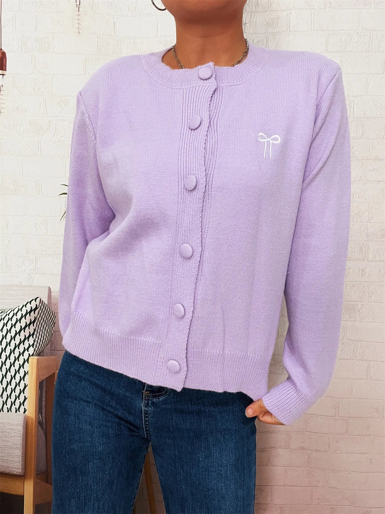 Light purple button-up long sleeve cardigan with knit texture and button front.