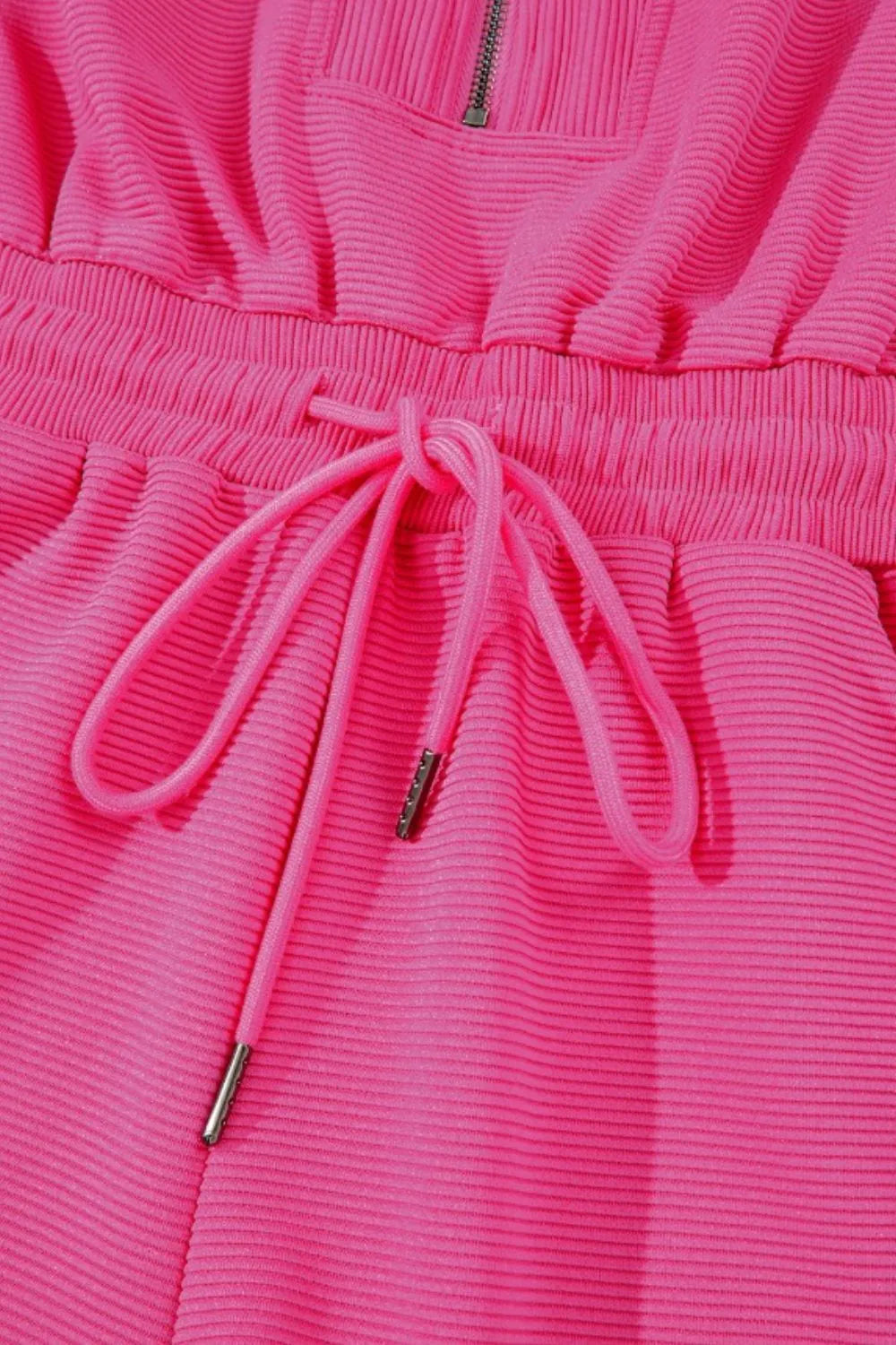 Hot pink textured drawstring waist close-up with two hanging tie cords