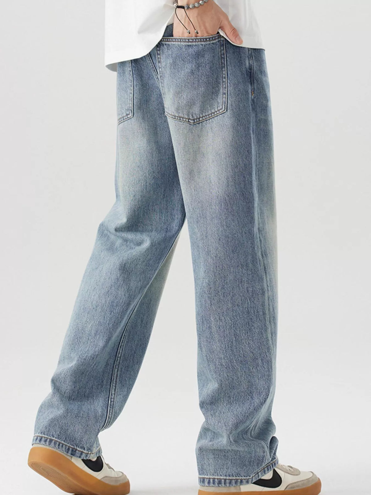 Blue vintage-wash cotton jeans, rear view with back yoke and two back pockets