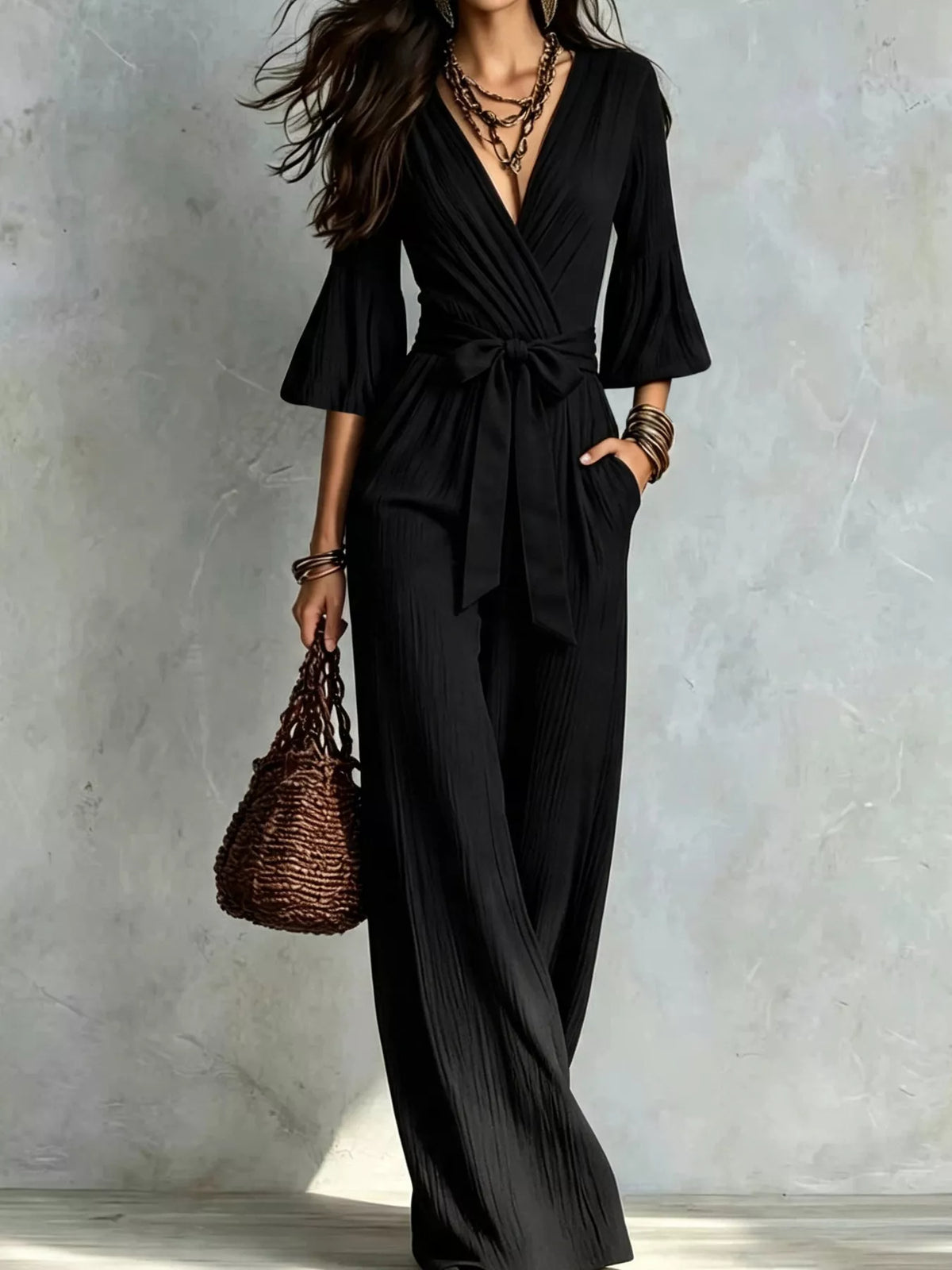 Black pleated tie-waist wide-leg jumpsuit with V-neck and belted waist