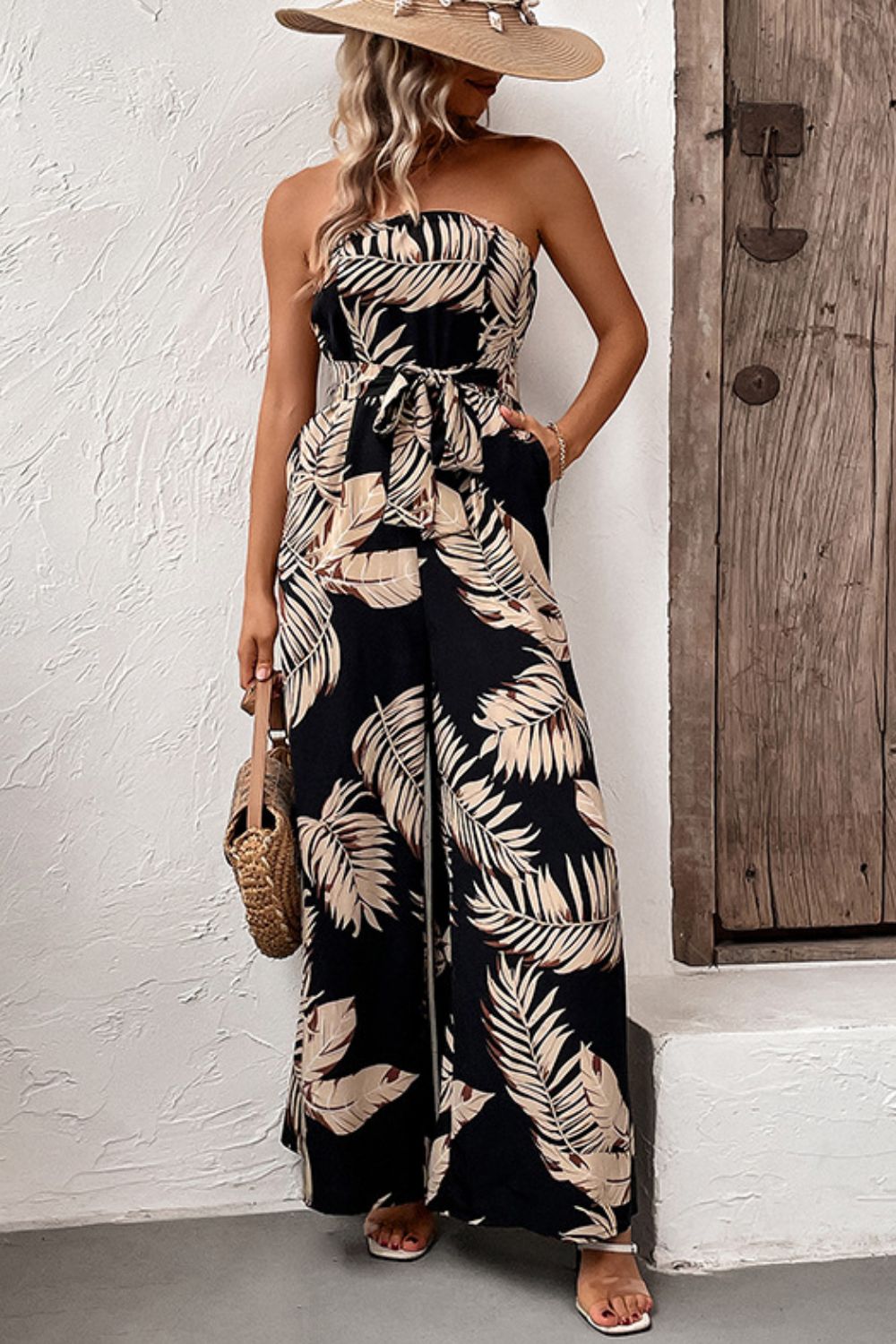 Perfee strapless wide-leg jumpsuit in black with beige leaf print, cinched waist