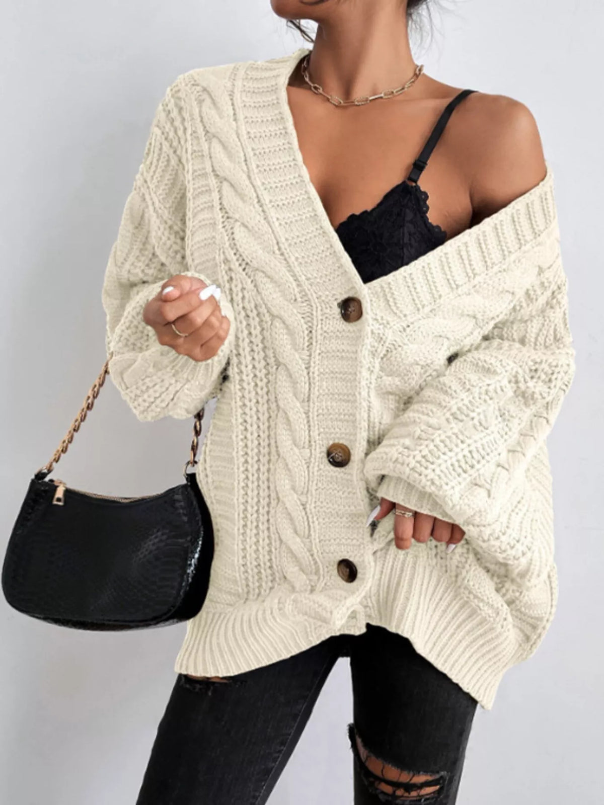 Off-white oversized cable-knit V-neck button cardigan with long sleeves and ribbed trim